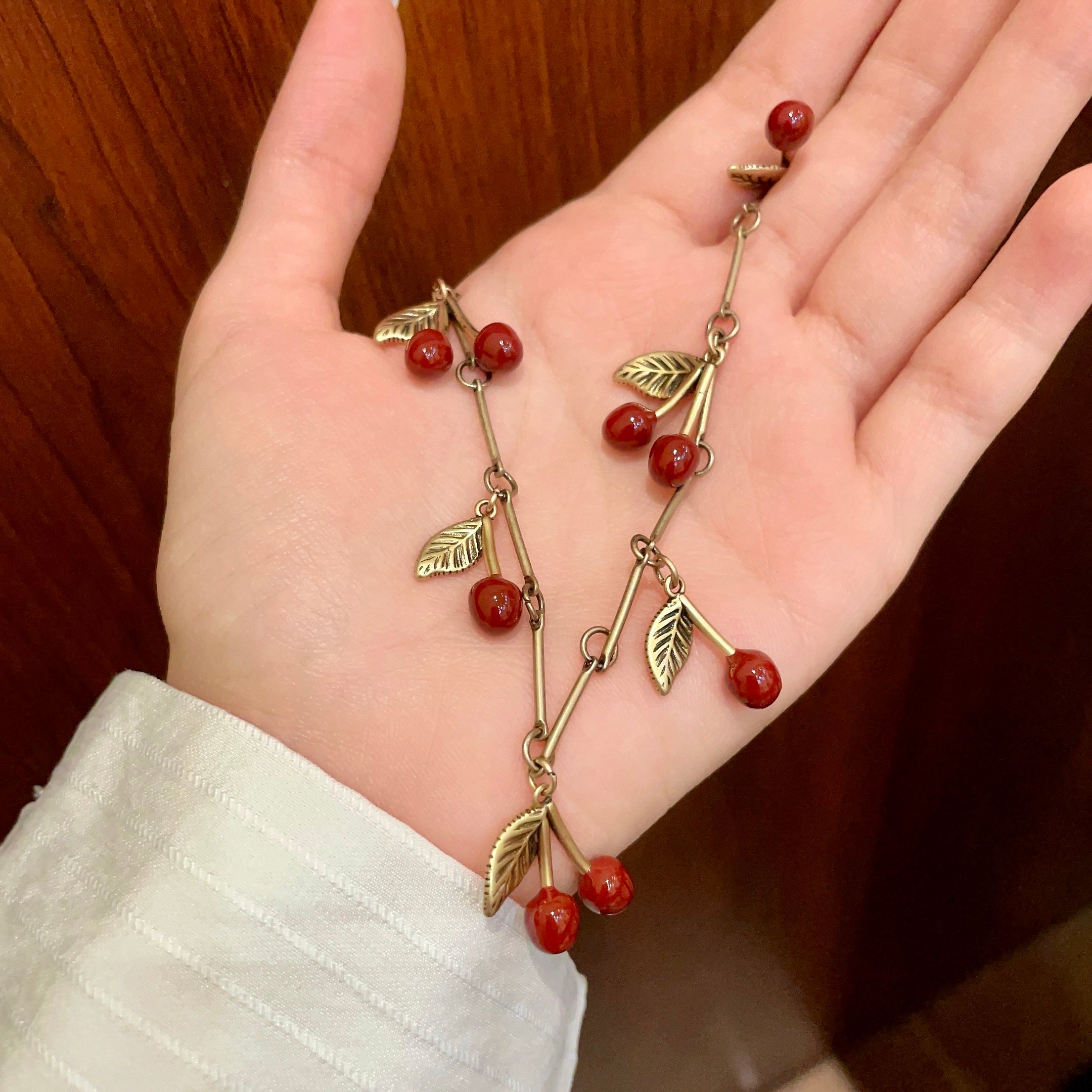 Saint Laurent 1961 Cherry Charm necklace antique gold metal deep red enamel cherry charms 42cm