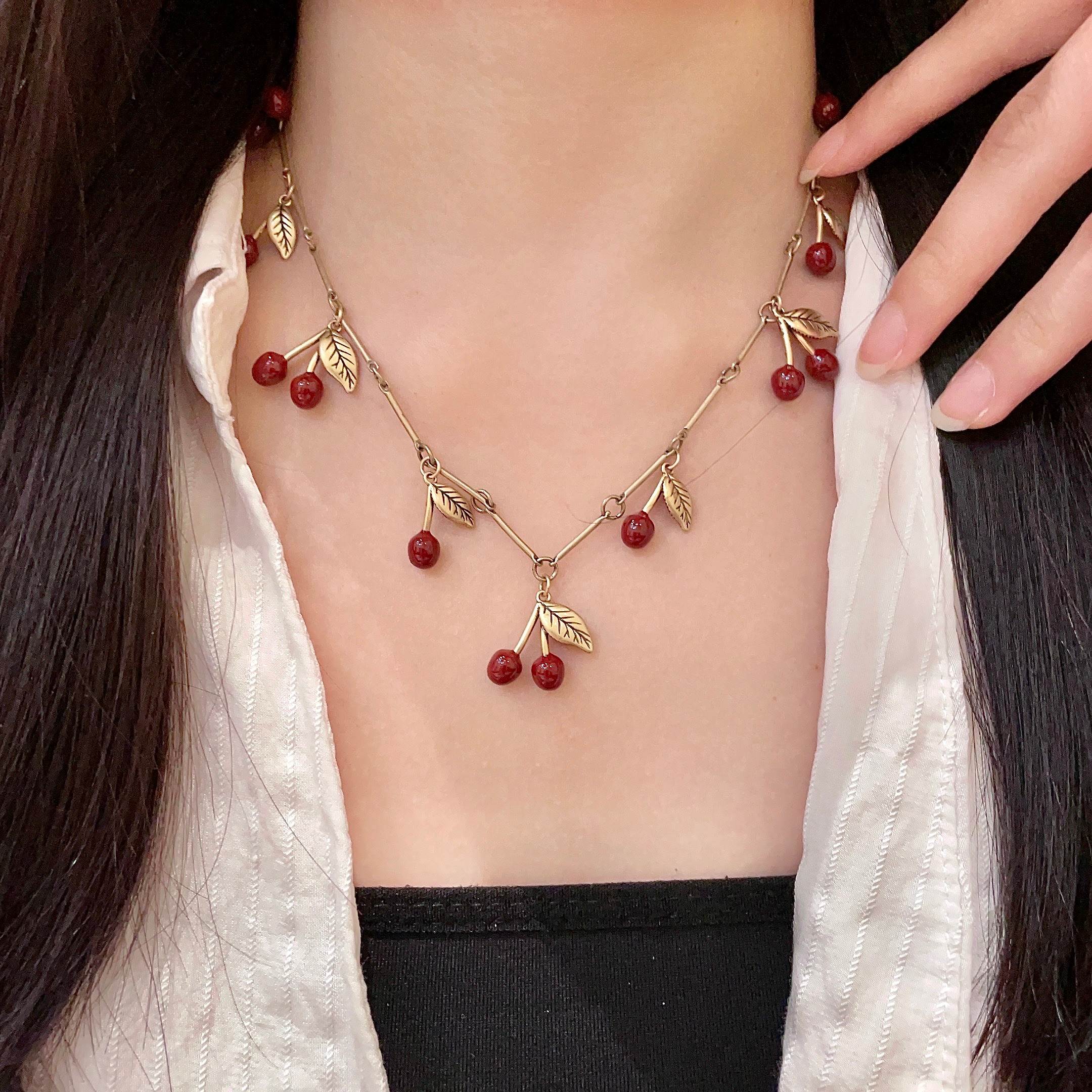 Saint Laurent Cherry Charm necklace antique gold tone metal deep red enamel cherry accents 42cm with 5cm extender