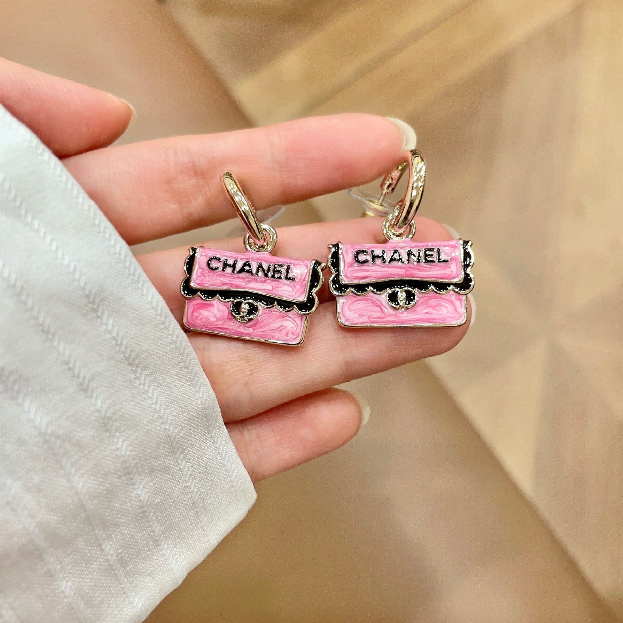 Chanel CC Logo Handbag Charm Drop Earrings earrings Gold-tone metal with pink enamel black enamel lettering and trim silver-tone turnlock detail 1 5cm hoop diameter 2cm total drop length