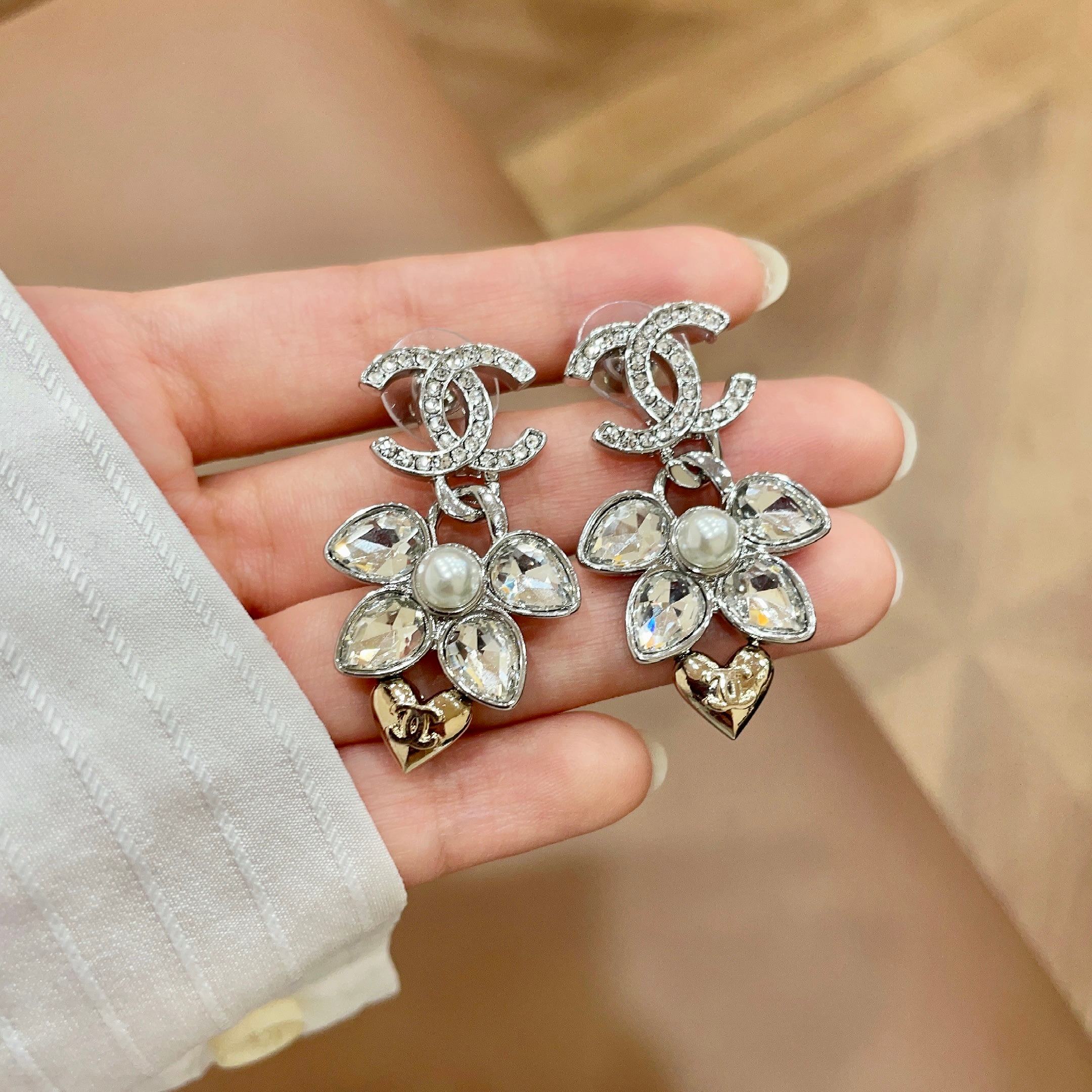 Chanel CC Logo Flower Heart Drop Earrings earrings Silver-tone metal with clear crystals white faux pearl and gold-tone heart accent Approximately 3cm drop length