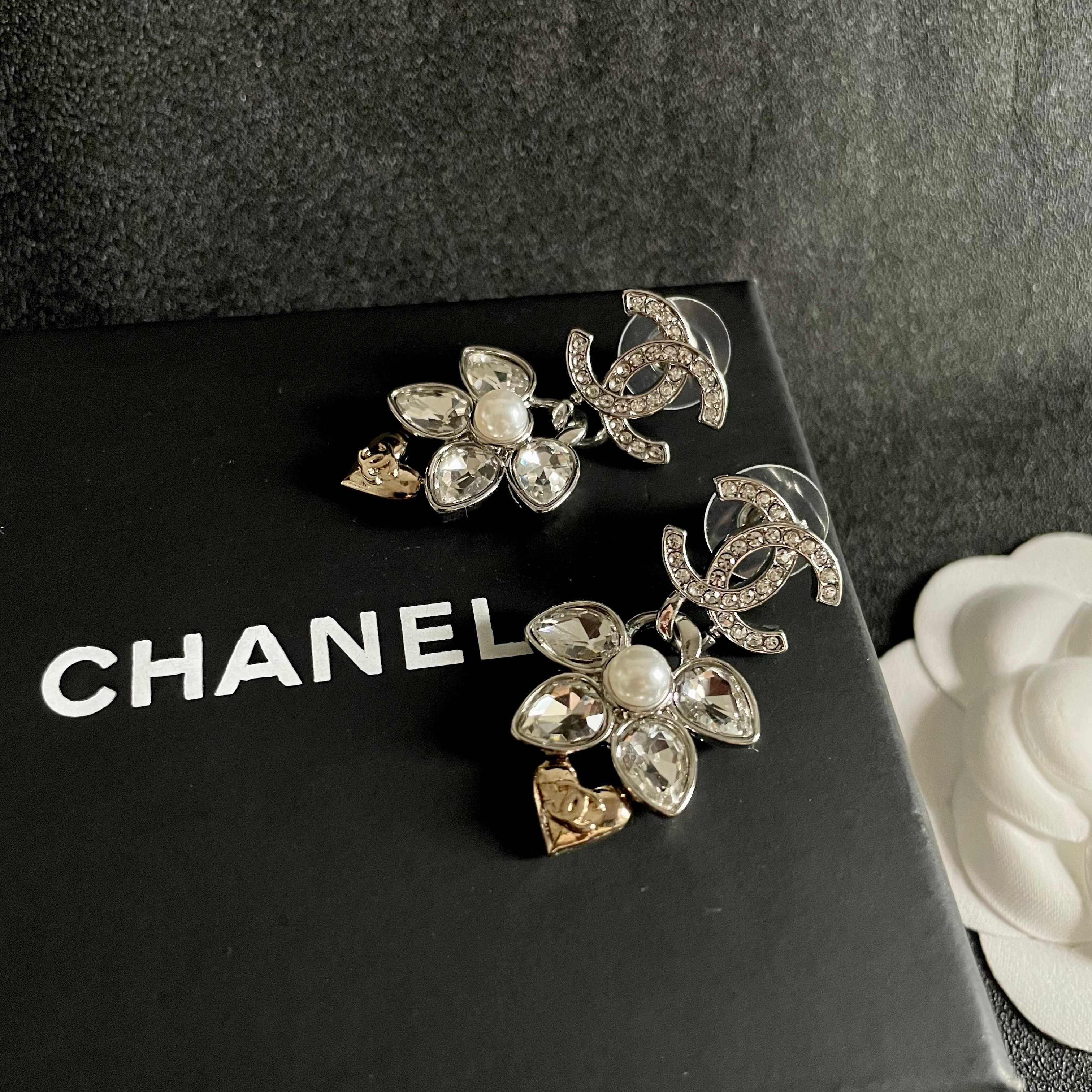 Chanel CC Logo Flower Heart Drop Earrings earrings Silver-tone metal with clear crystals white faux pearl and gold-tone heart accent Approximately 3cm drop length