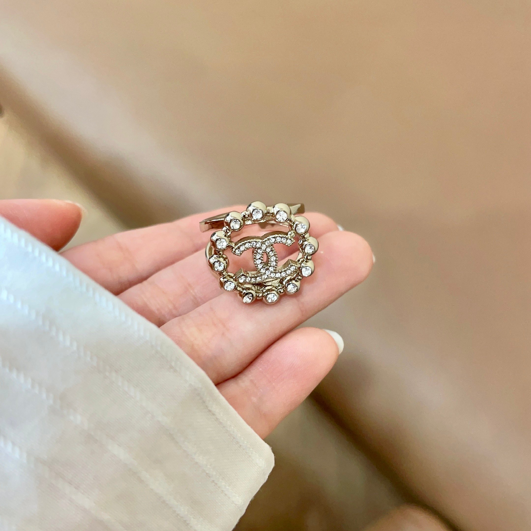 Chanel CC Logo Crystal Embellished Open Ring ring Light gold-tone metal with clear crystal accents Adjustable open band US size 7 equivalent