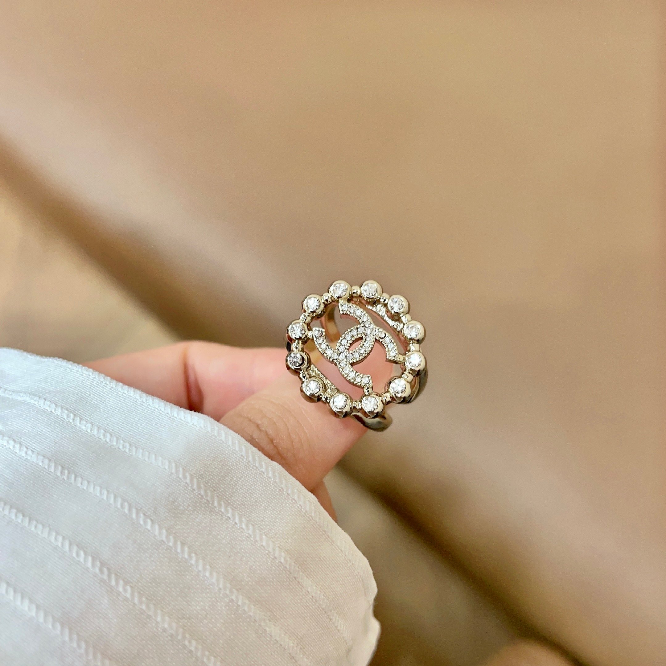 Chanel CC Logo Crystal Embellished Open Ring ring Light gold-tone metal with clear crystal accents Adjustable open band US size 7 equivalent