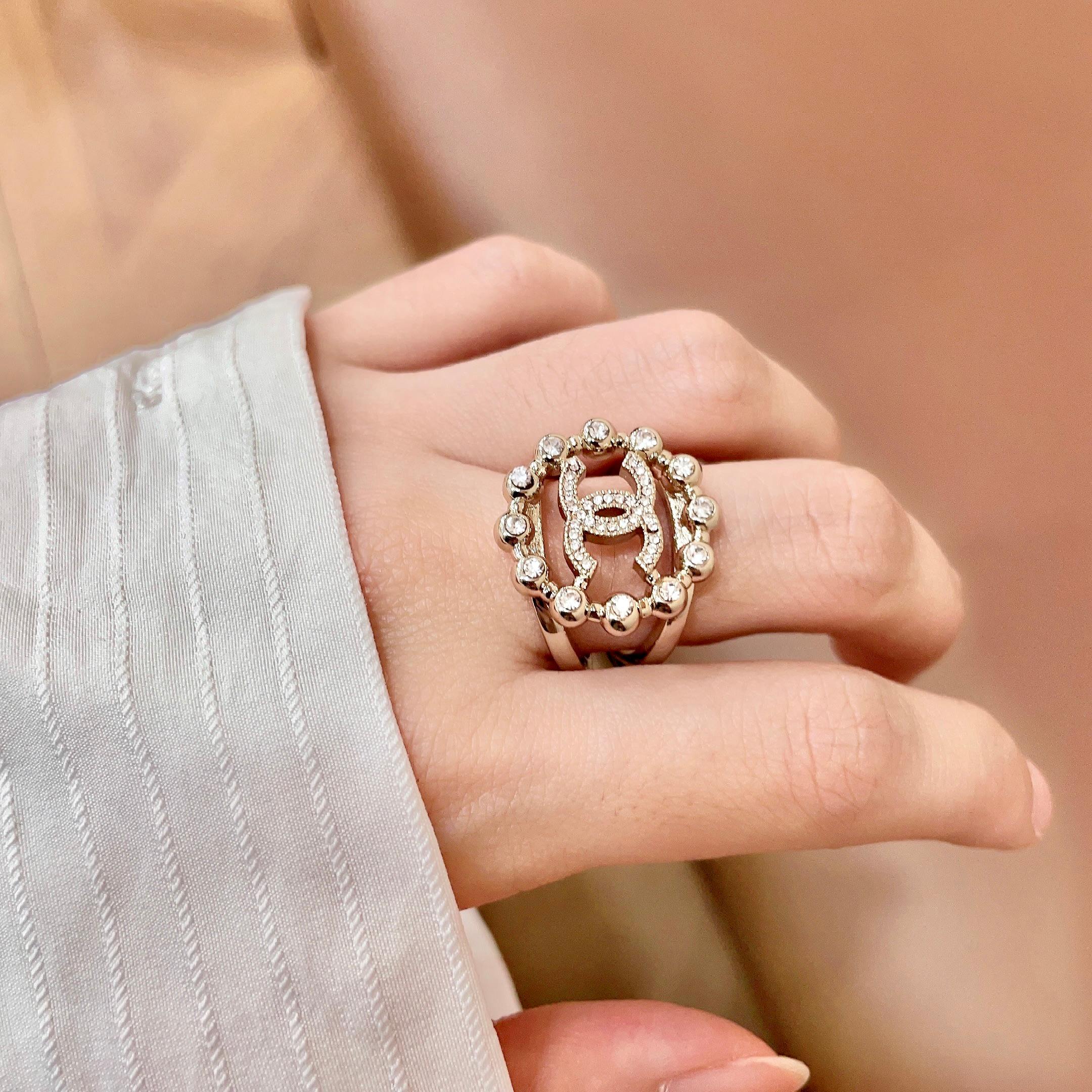 Chanel CC Logo Crystal Embellished Open Ring ring Light gold-tone metal with clear crystal accents Adjustable open band US size 7 equivalent