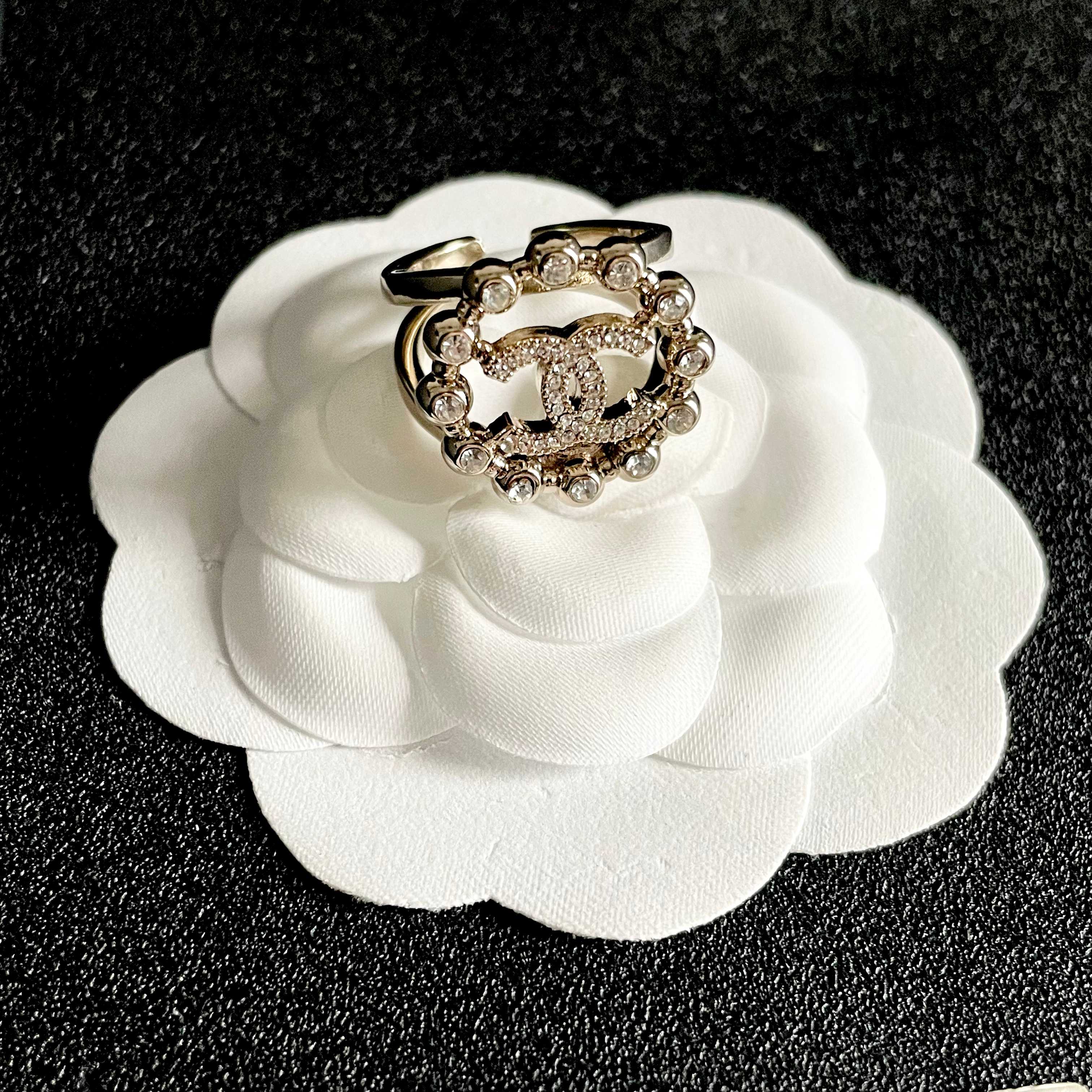 Chanel CC Logo Crystal Embellished Open Ring ring Light gold-tone metal with clear crystal accents Adjustable open band US size 7 equivalent
