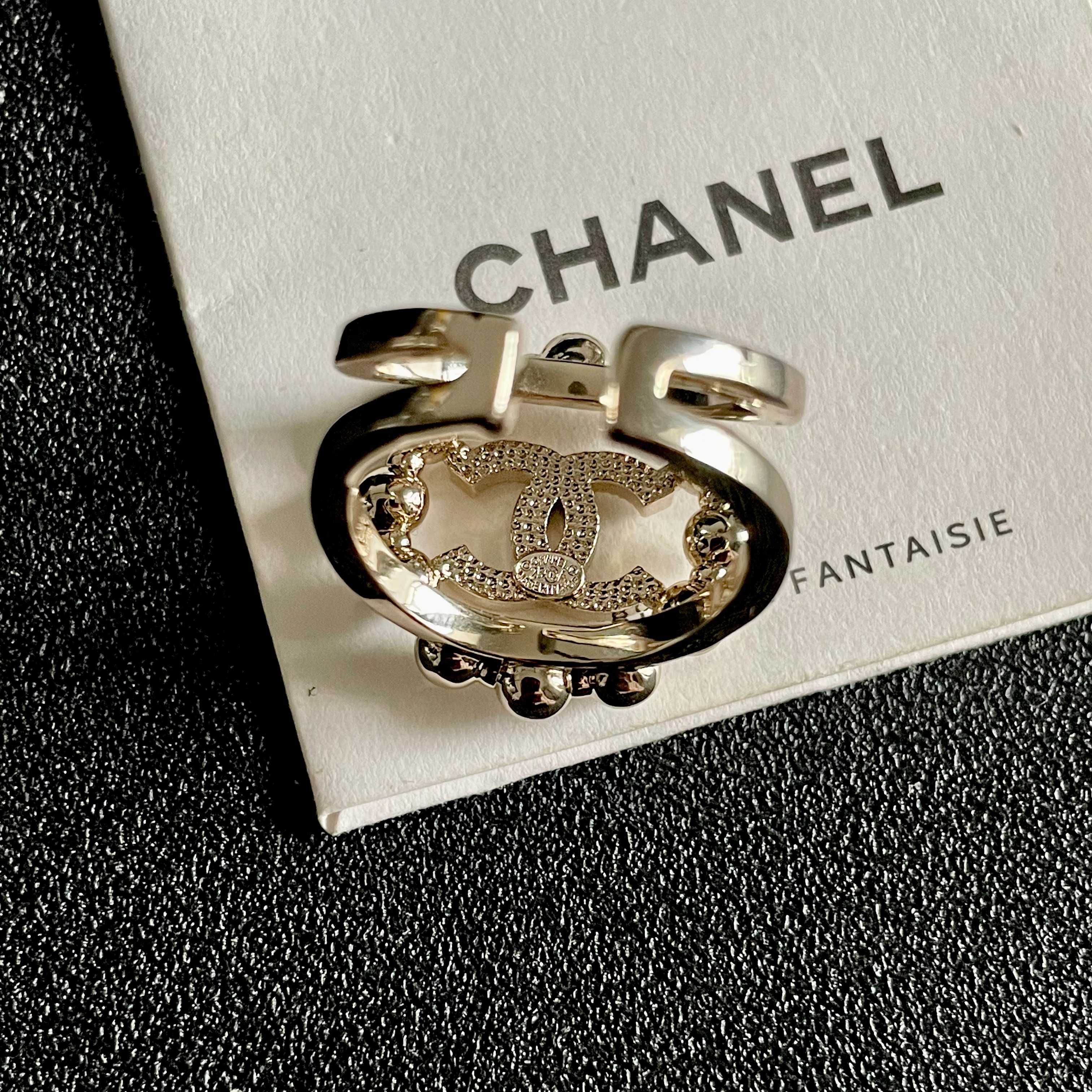 Chanel CC Logo Crystal Embellished Open Ring ring Light gold-tone metal with clear crystal accents Adjustable open band US size 7 equivalent