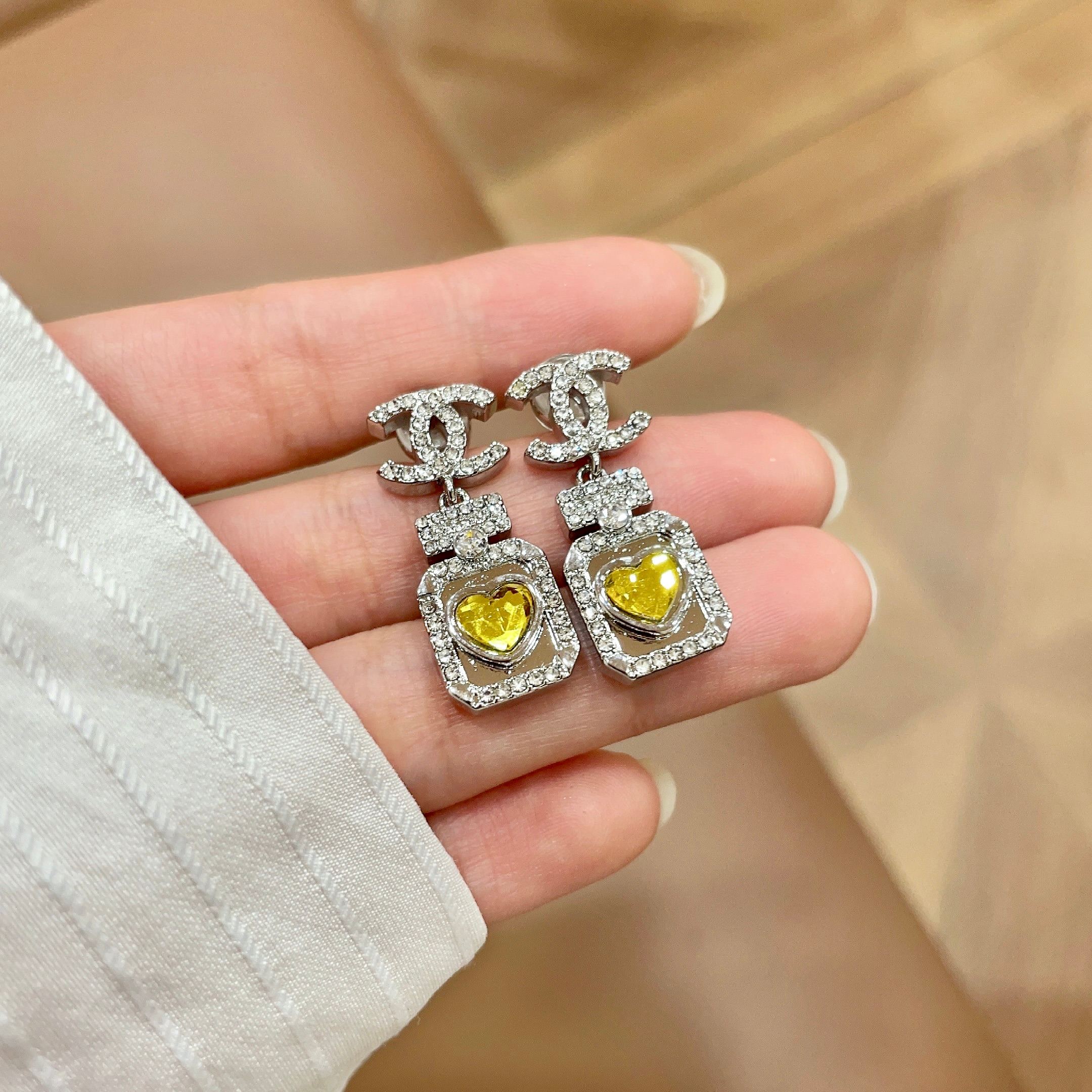 Chanel CC Logo Perfume Bottle Heart Drop Earrings earrings silver-tone metal with clear crystals and yellow heart-shaped gemstone 2 5cm drop length