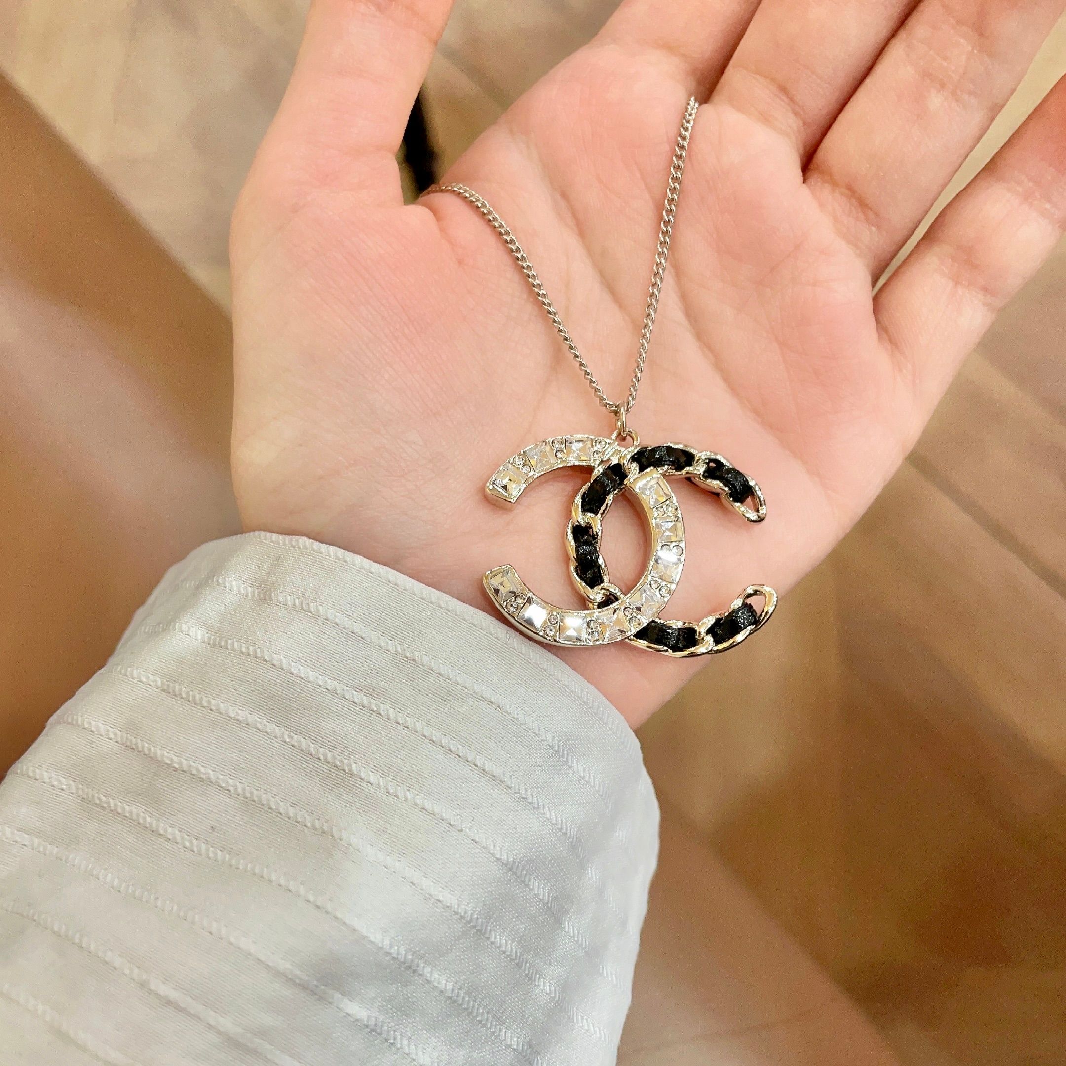 Chanel CC Logo Crystal Leather Woven Pendant Necklace necklace Gold-tone metal with clear faceted crystals and black woven leather accents 42cm