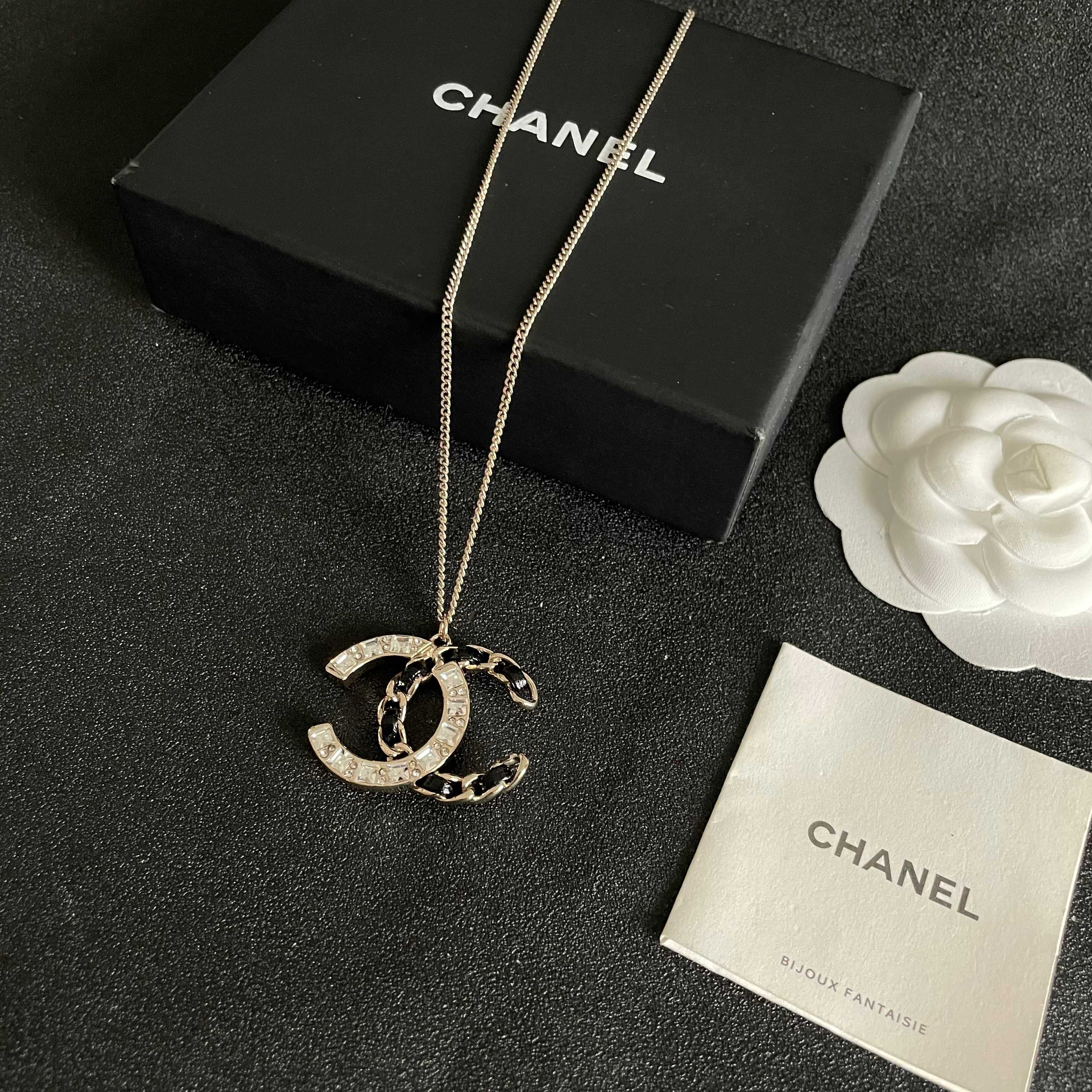 Chanel CC Logo Crystal Leather Woven Pendant Necklace necklace Gold-tone metal with clear faceted crystals and black woven leather accents 42cm