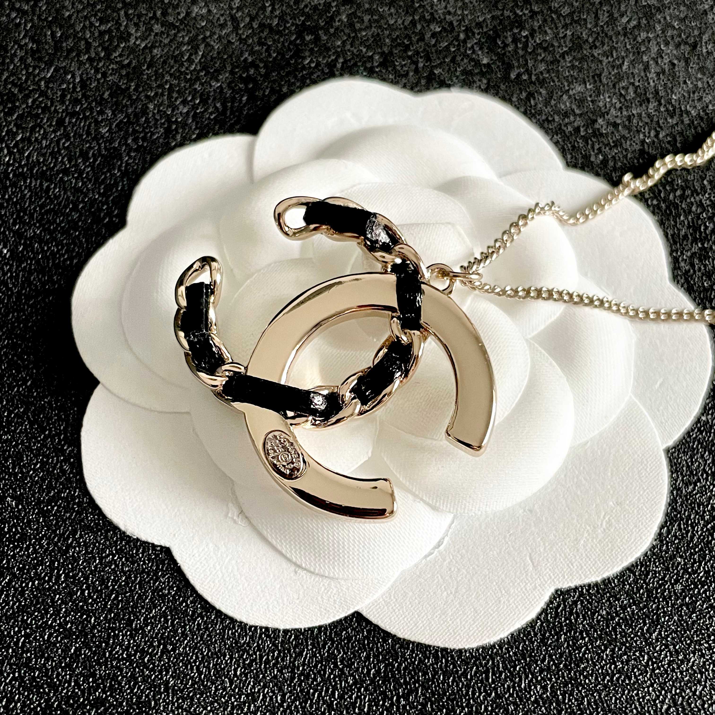 Chanel CC Logo Crystal Leather Woven Pendant Necklace necklace Gold-tone metal with clear faceted crystals and black woven leather accents 42cm