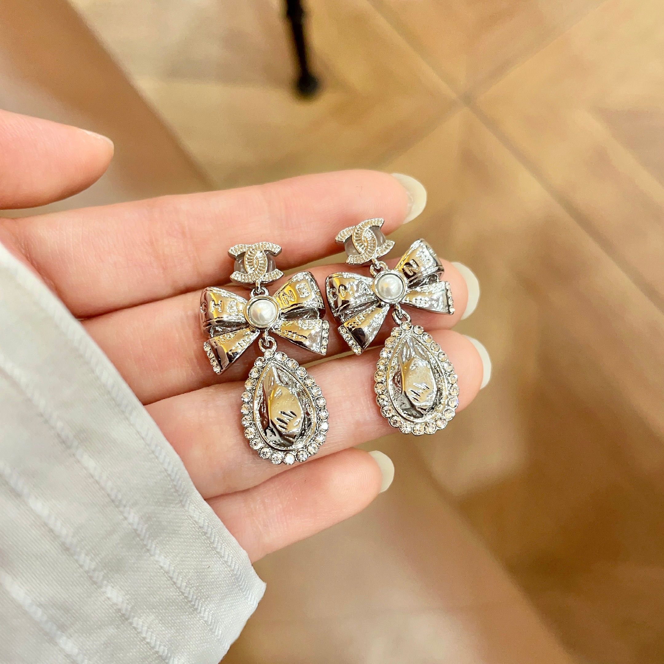 Chanel CC Bow Teardrop Crystal Pearl Drop Earrings earrings Silver-toned metal with white faux pearl and clear crystal accents Approximately 3 5cm drop length