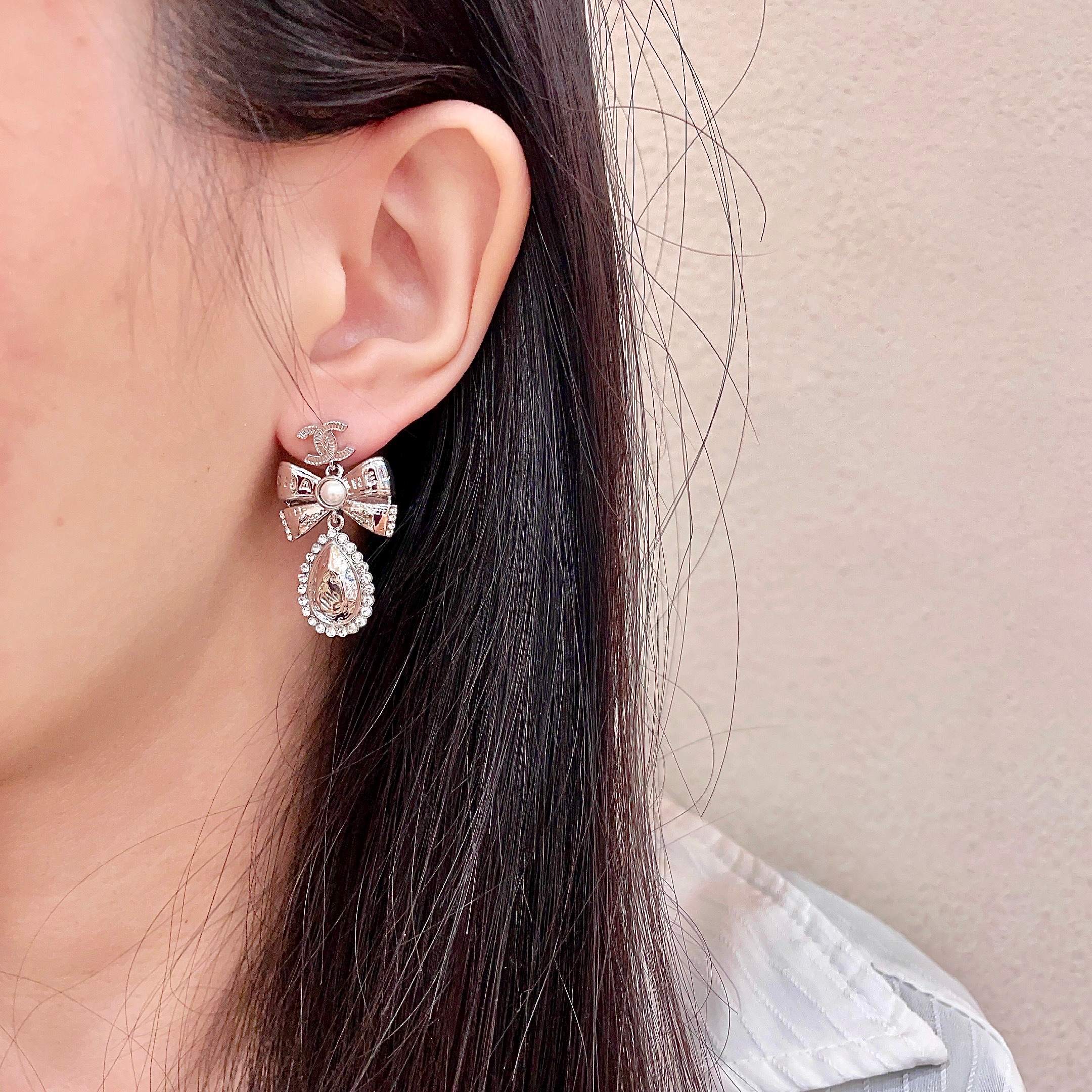 Chanel CC Bow Teardrop Crystal Pearl Drop Earrings earrings Silver-toned metal with white faux pearl and clear crystal accents Approximately 3 5cm drop length
