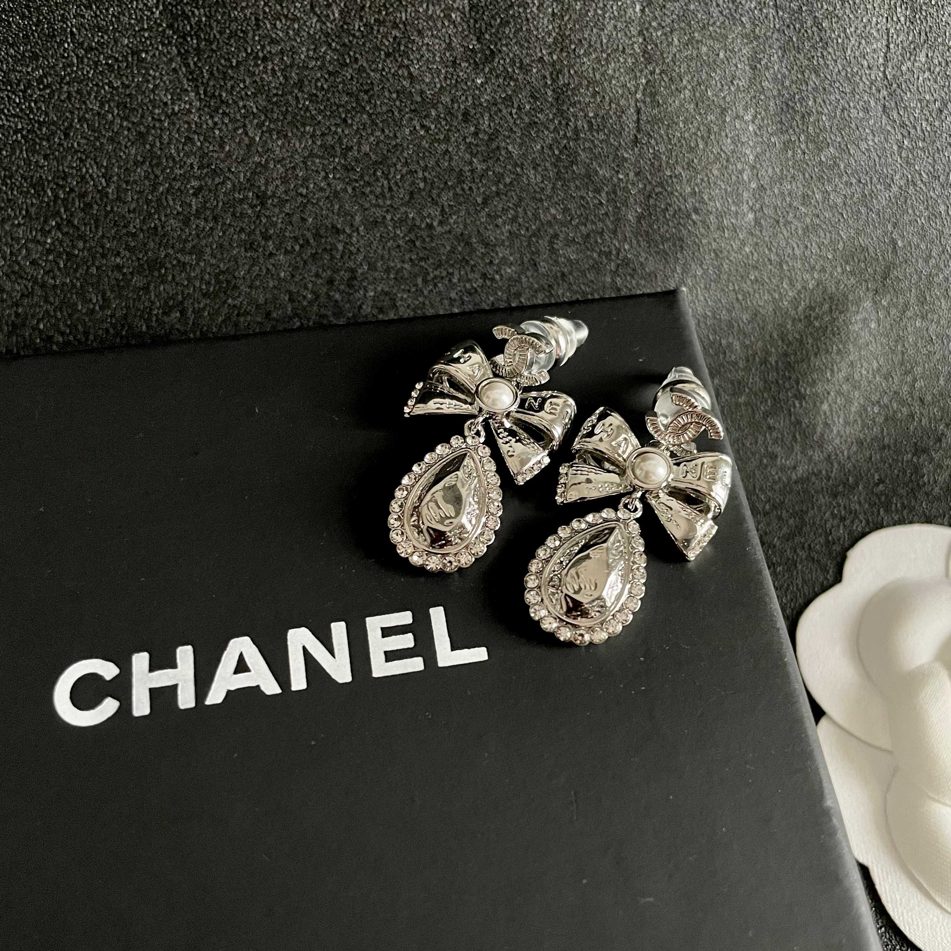 Chanel CC Bow Teardrop Crystal Pearl Drop Earrings earrings Silver-toned metal with white faux pearl and clear crystal accents Approximately 3 5cm drop length