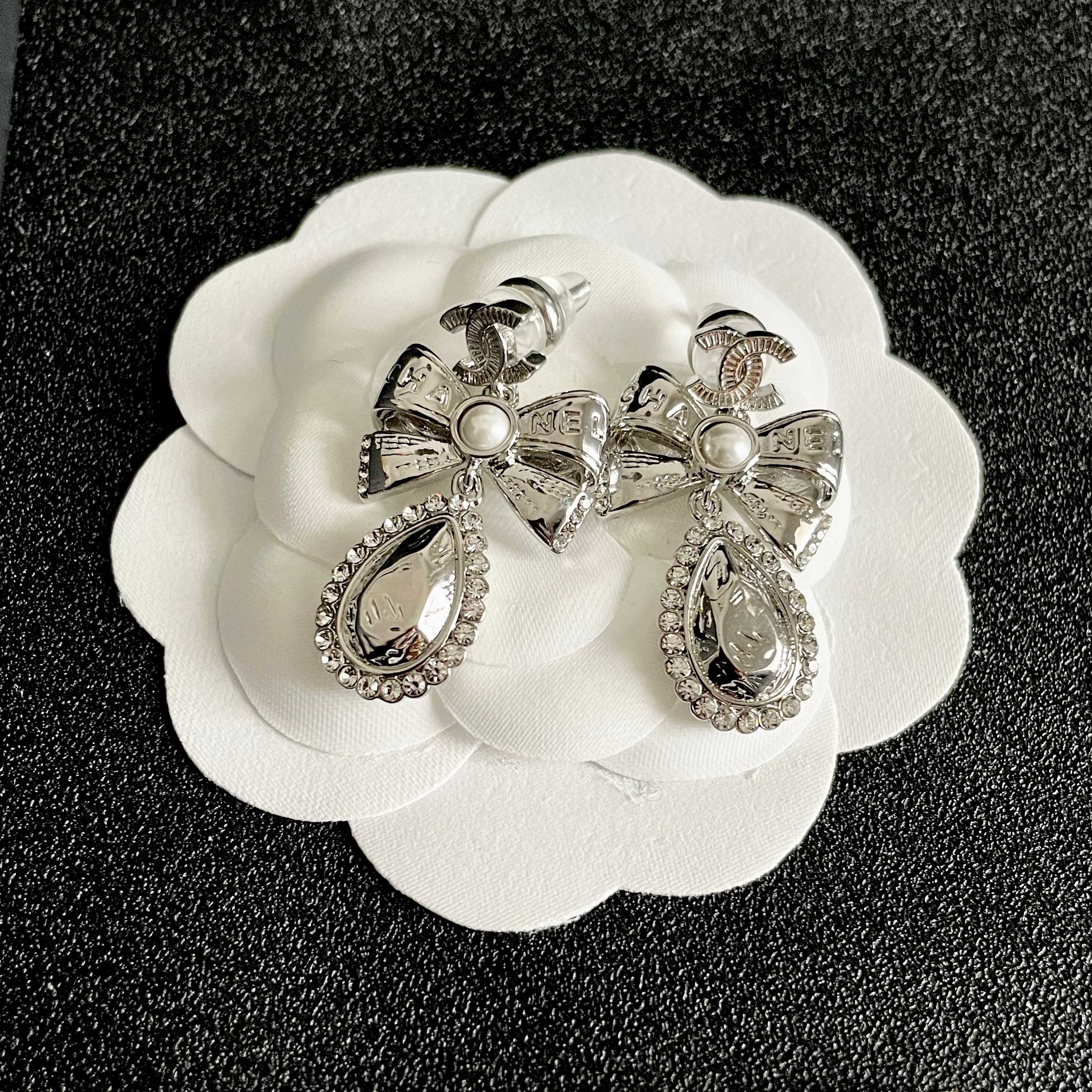 Chanel CC Bow Teardrop Crystal Pearl Drop Earrings earrings Silver-toned metal with white faux pearl and clear crystal accents Approximately 3 5cm drop length