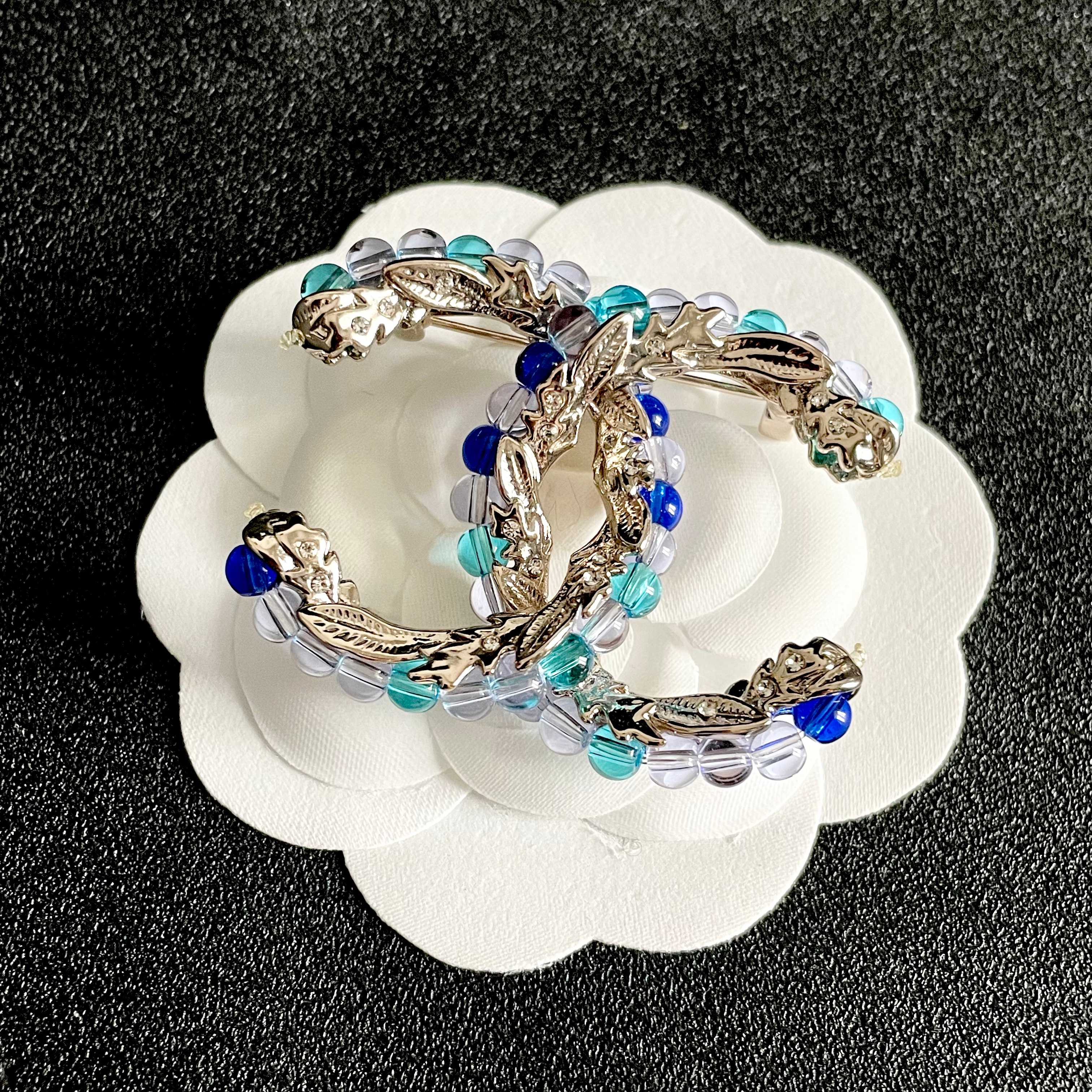Chanel CC Logo Beaded Brooch brooch gold-tone metal with blue teal purple and pink glass beads 3 5cm width