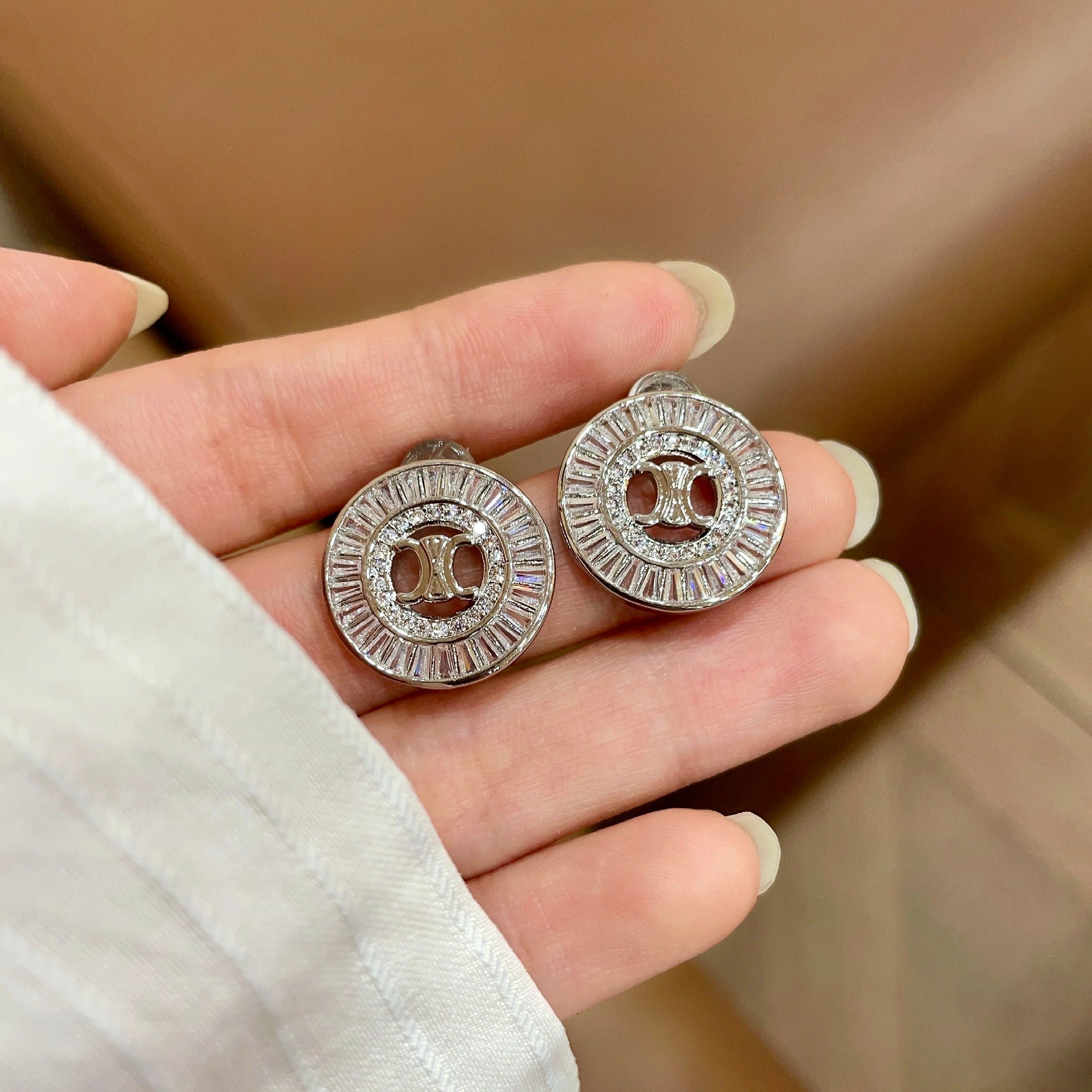 Celine Triomphe Rhinestone Circle Stud Earrings earrings Two variants gold-tone metal with clear baguette-cut crystals silver-tone metal with clear baguette-cut crystals 1 5cm diameter