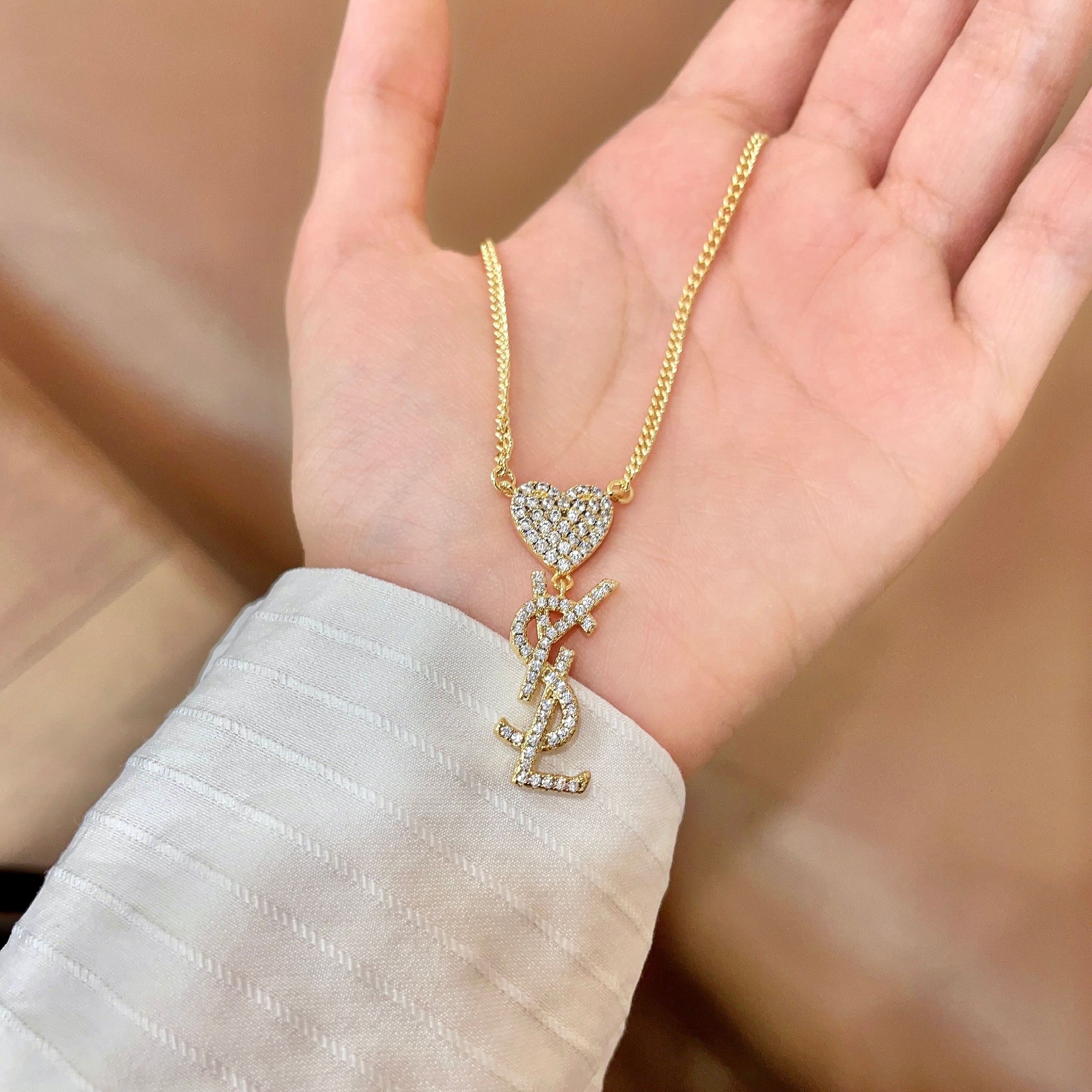 Saint Laurent 1961 Heart Monogram Pendant necklace Gold-tone metal with clear pave crystals 45cm