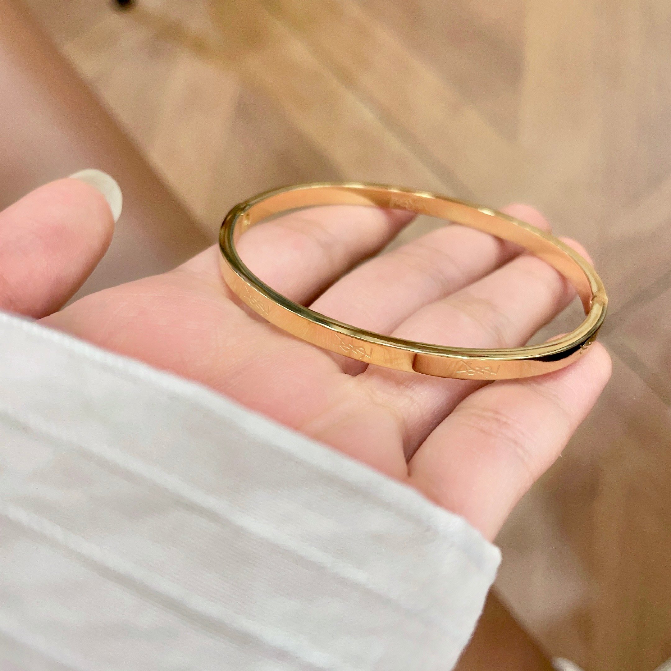 Saint Laurent Cassandre Logo Engraved Hinged Bangle bracelet 18K gold tone metal no accent stones 17cm inner circumference