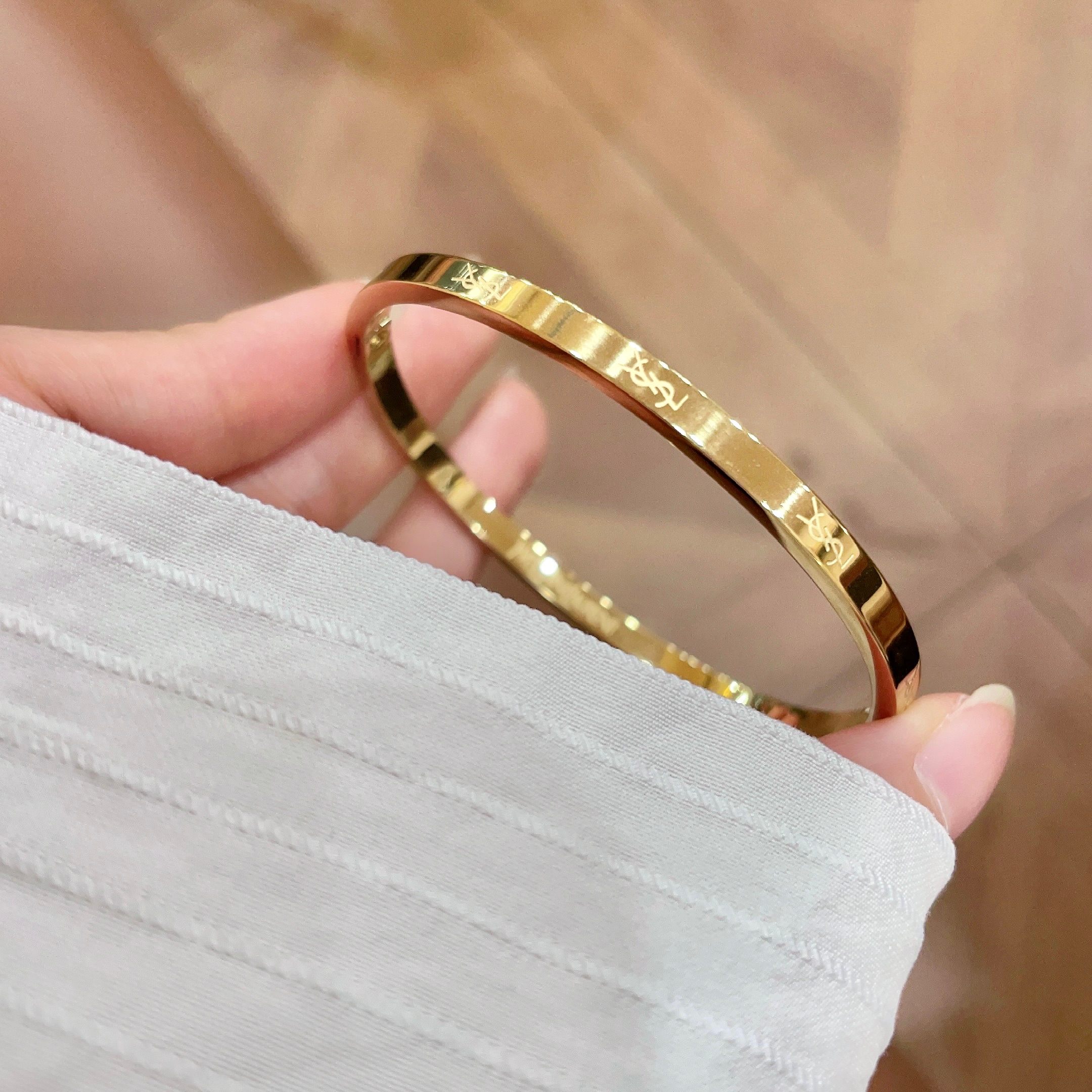 Saint Laurent Cassandre Logo Engraved Hinged Bangle bracelet 18K gold tone metal no accent stones 17cm inner circumference