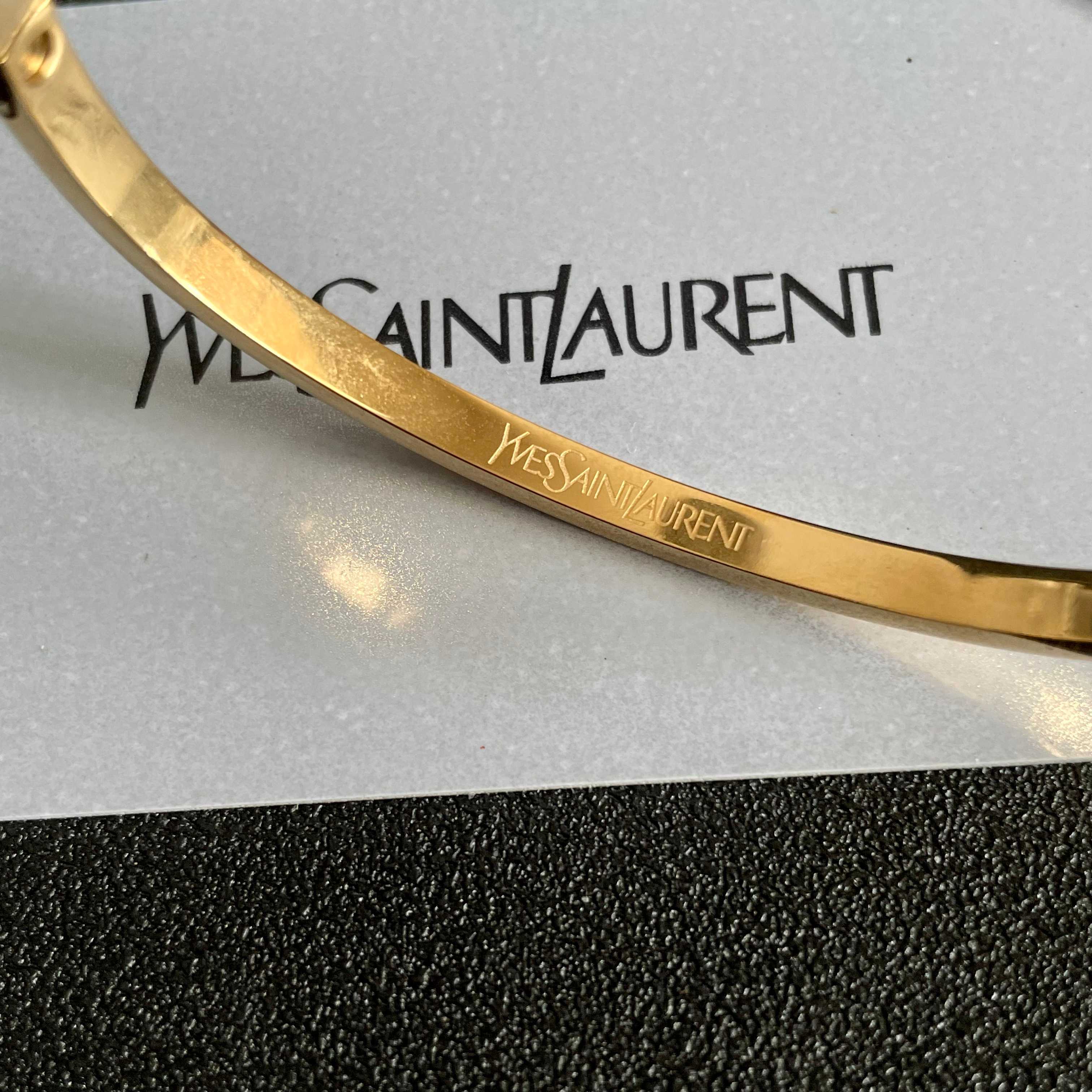 Saint Laurent Cassandre Logo Engraved Hinged Bangle bracelet 18K gold tone metal no accent stones 17cm inner circumference