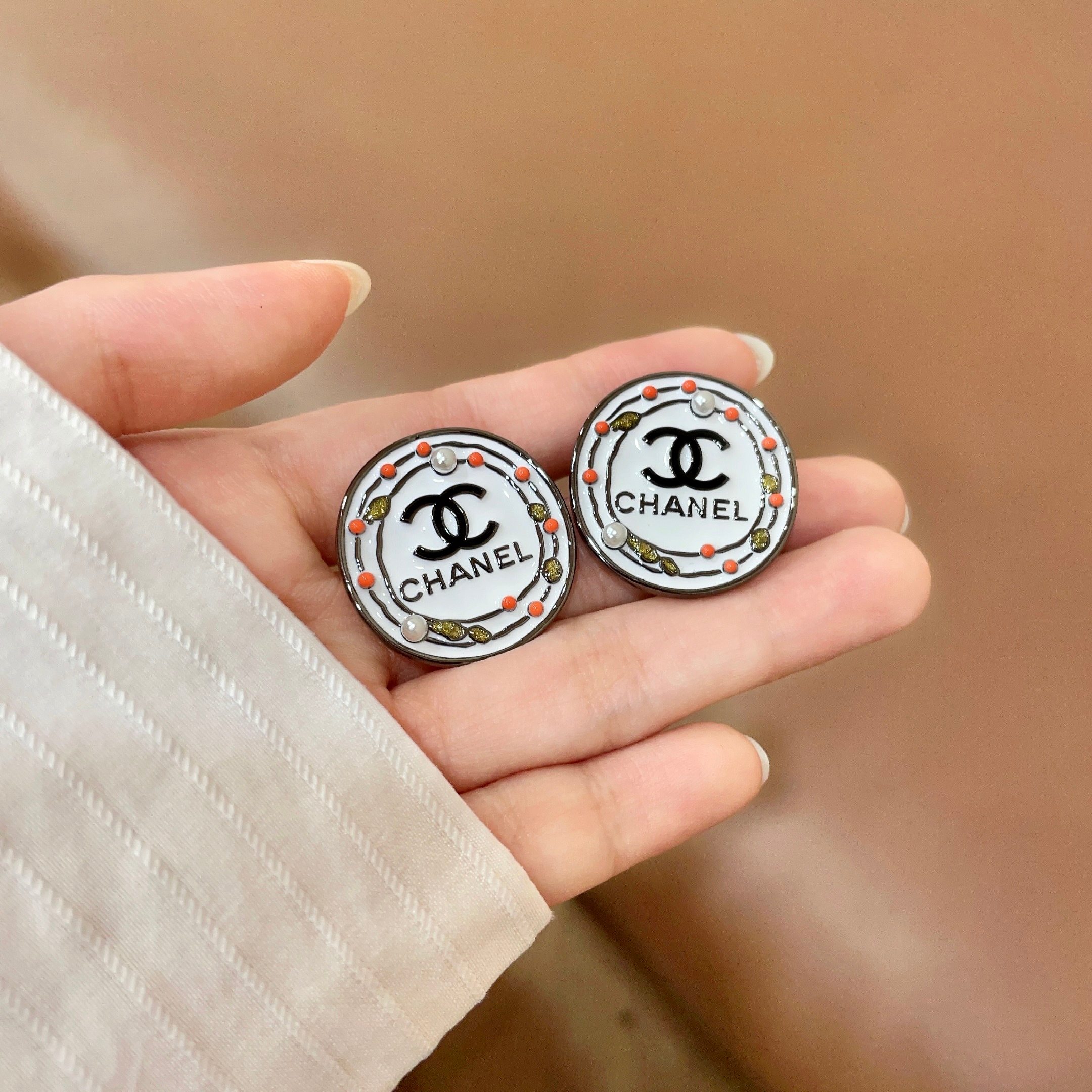 Chanel CC Logo Round Stud Earrings earrings Silver-tone metal with white enamel base black CC logo and text coral red and gold decorative accents faux pearl details 2cm diameter