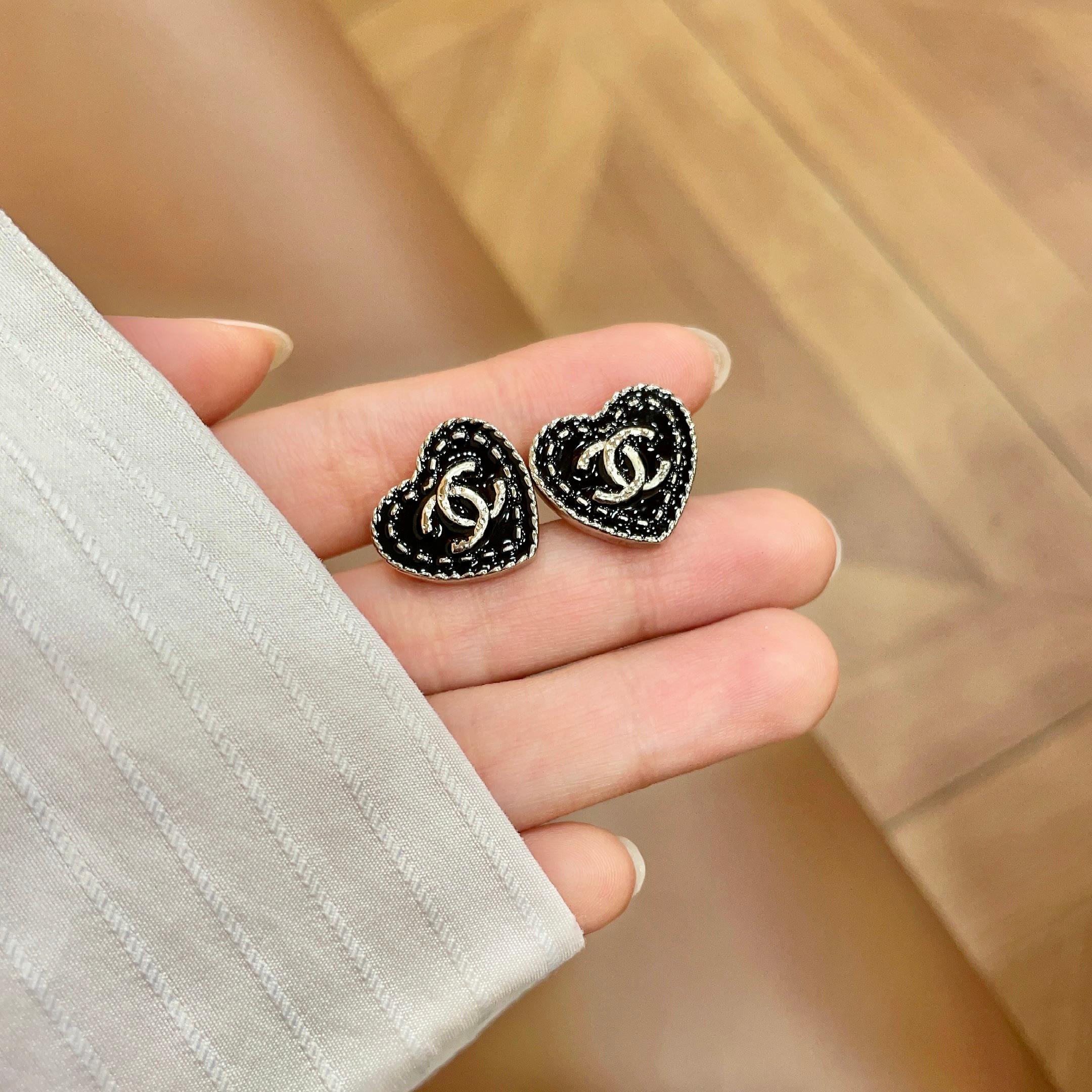 Chanel CC Heart Stud Earrings earrings light gold tone metal with black enamel and silver-tone interlocking CC logo 1 5cm diameter