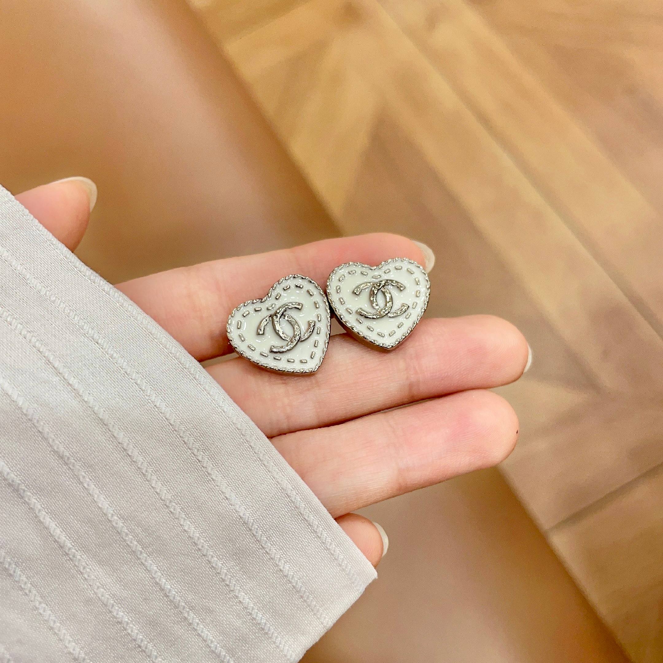 Chanel CC Heart Stitch Stud Earrings earrings light gold tone metal with white enamel and crystal accents 1 5cm stud diameter