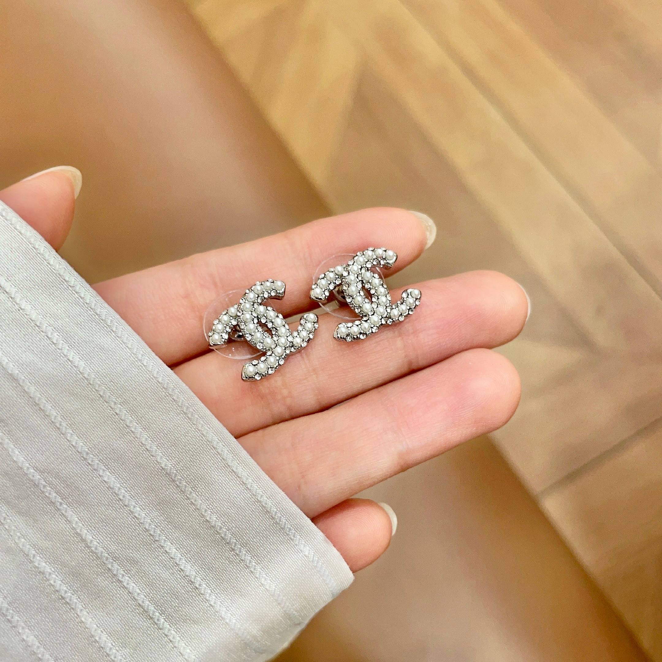 Chanel CC Logo Stud Earrings earrings silver-tone metal with clear crystal and white pearl embellishments 1 2cm diameter per earring