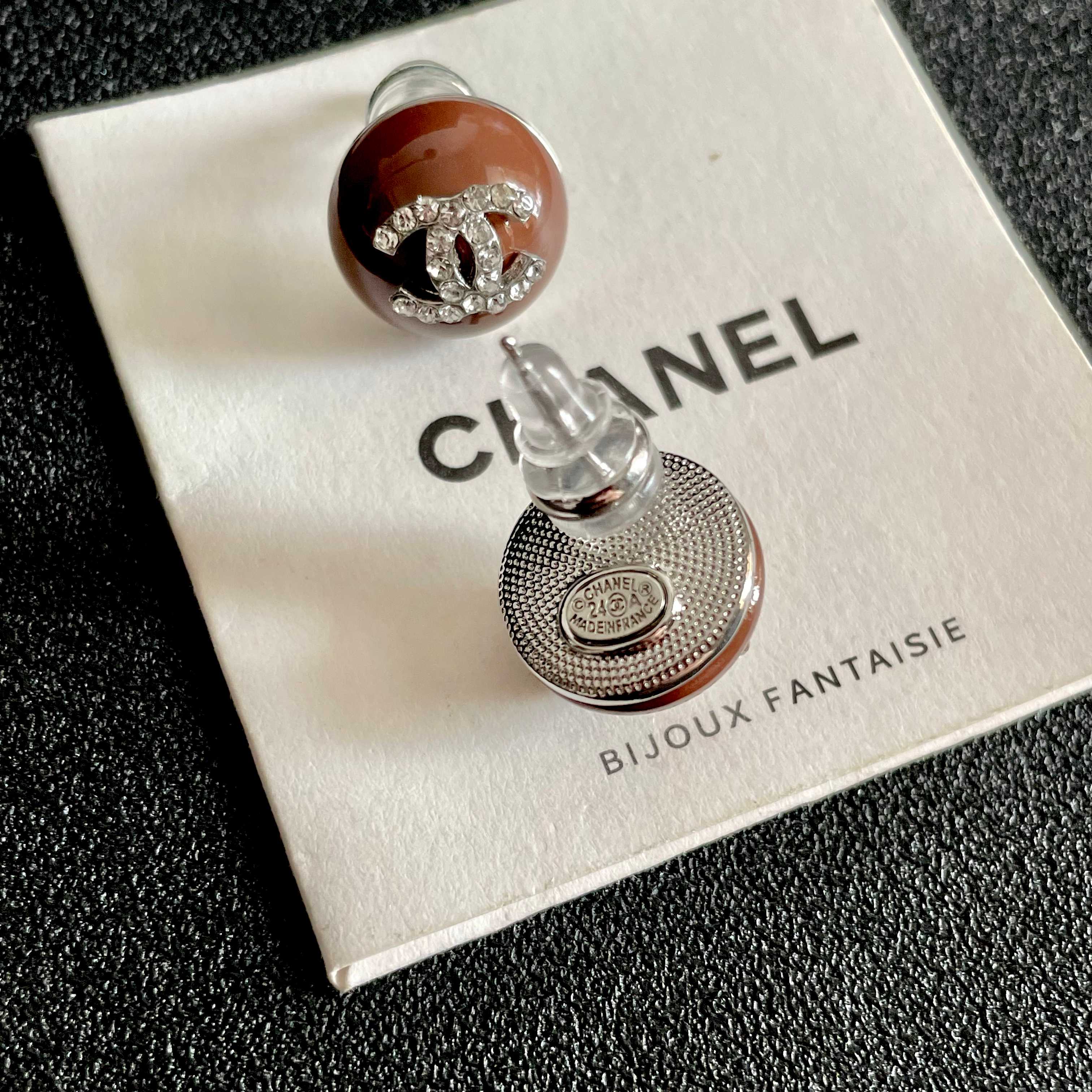Chanel CC Logo Round Stud Earrings earrings brown resin base with silver-tone metal and clear crystal CC logo 1 2cm diameter