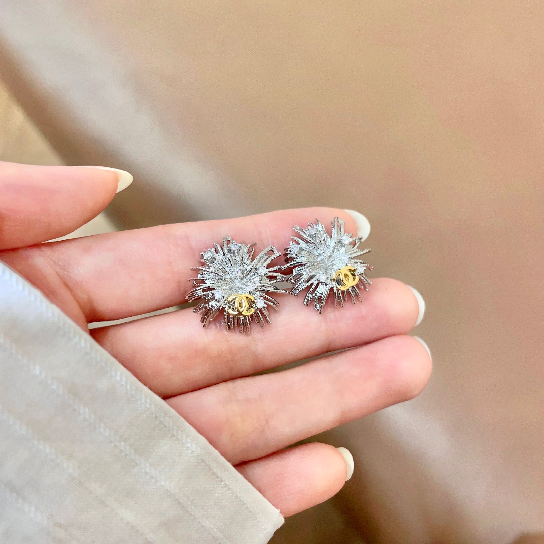 Chanel CC Sunburst Stud Earrings earrings silver-tone metal with clear crystal accents and gold-tone CC logo 1 5cm diameter