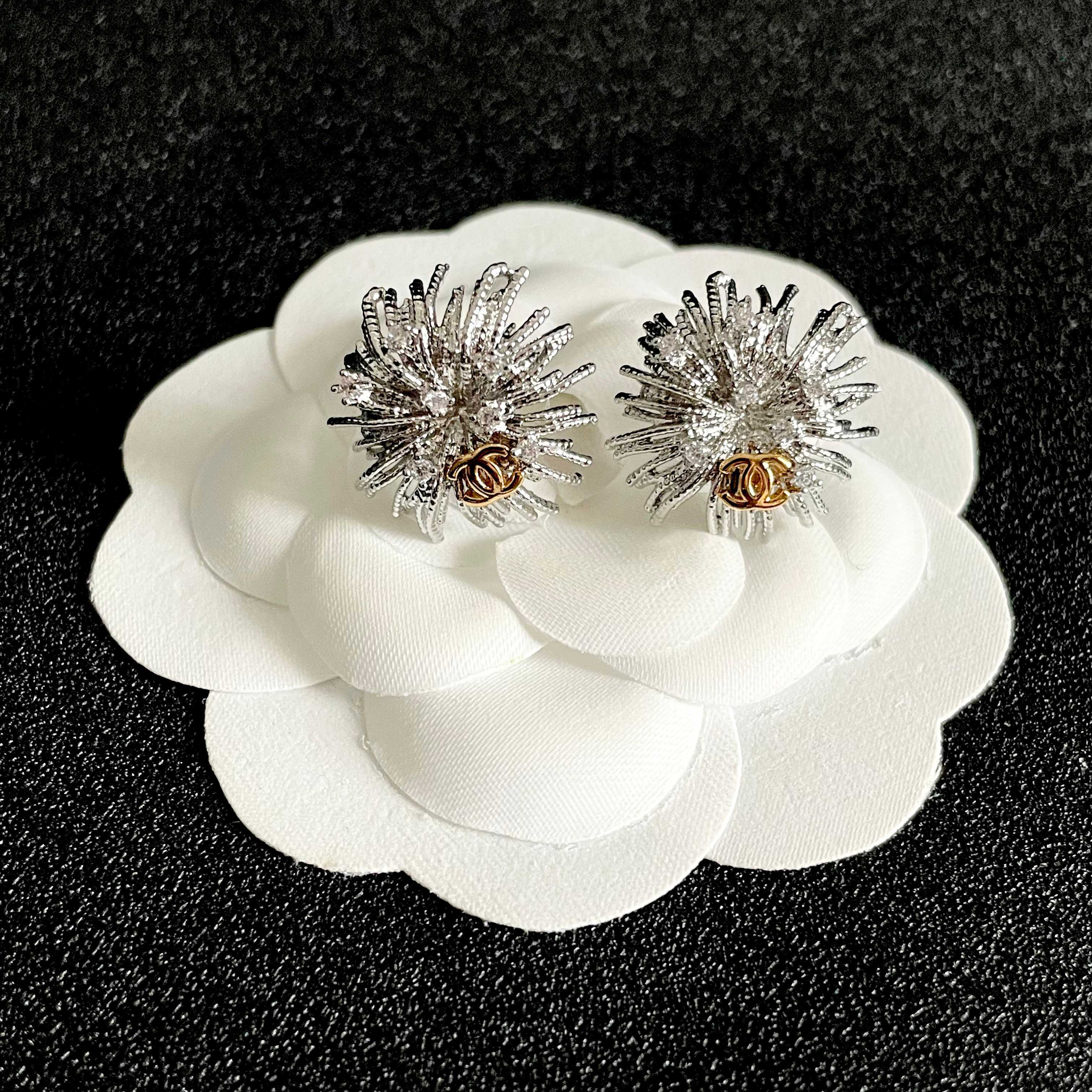 Chanel CC Sunburst Stud Earrings earrings silver-tone metal with clear crystal accents and gold-tone interlocking CC logo 2cm diameter