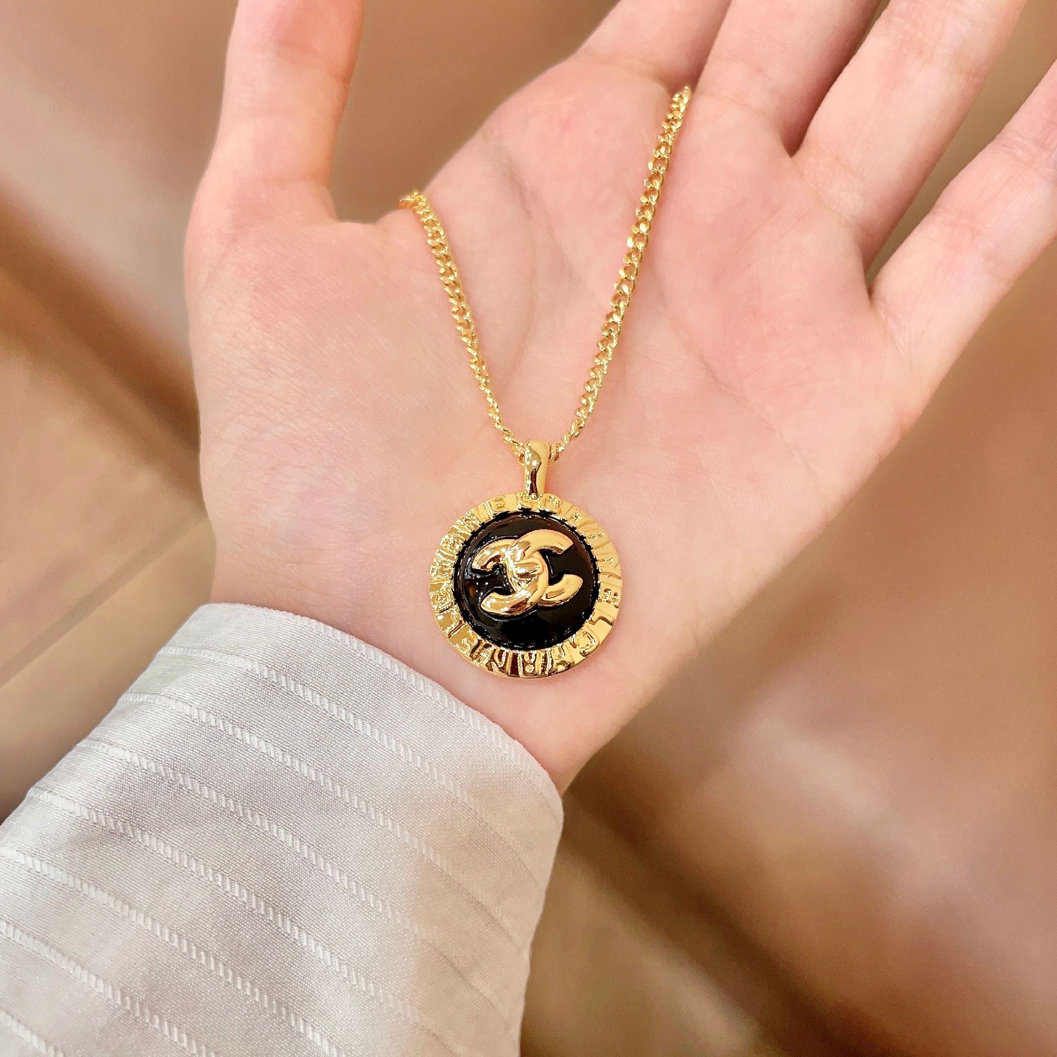Chanel CC Logo Round Medallion necklace Gold-tone metal with black enamel 42cm