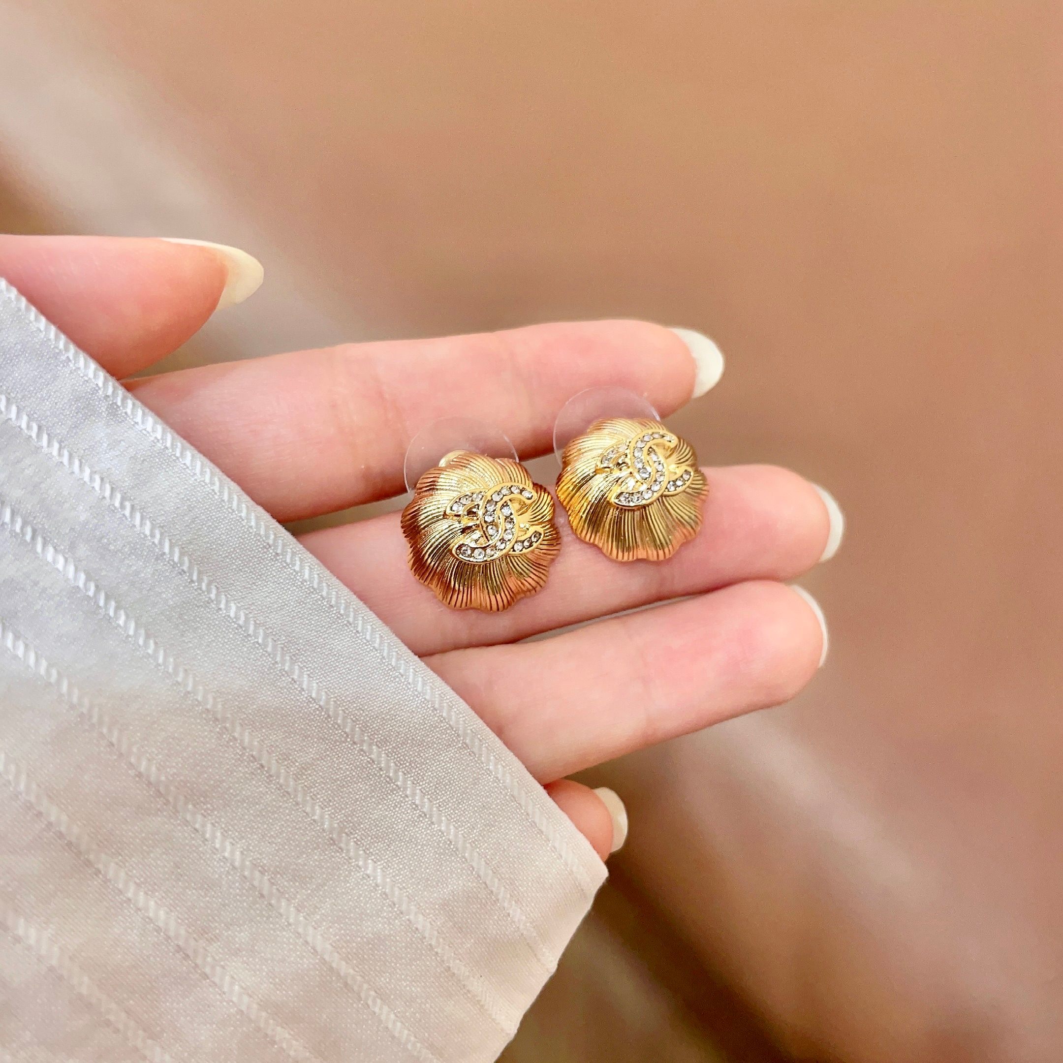 Chanel CC Logo Textured Flower Stud Earrings earrings Gold-tone metal with clear crystal accents 1 5cm diameter