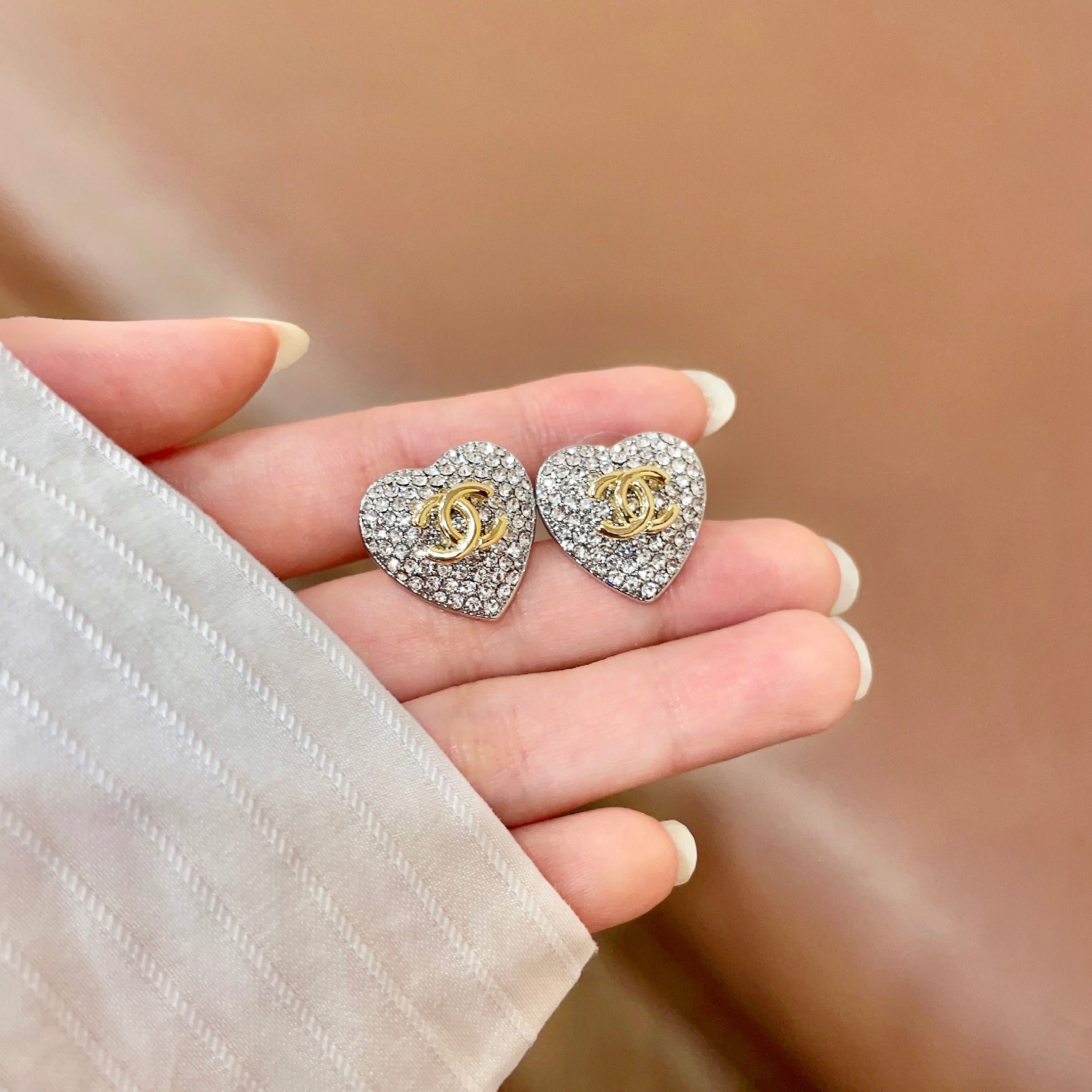 Chanel CC Heart Crystal Stud Earrings earrings silver-tone metal base gold-tone interlocking CC logo clear crystal pave 1 5cm diameter