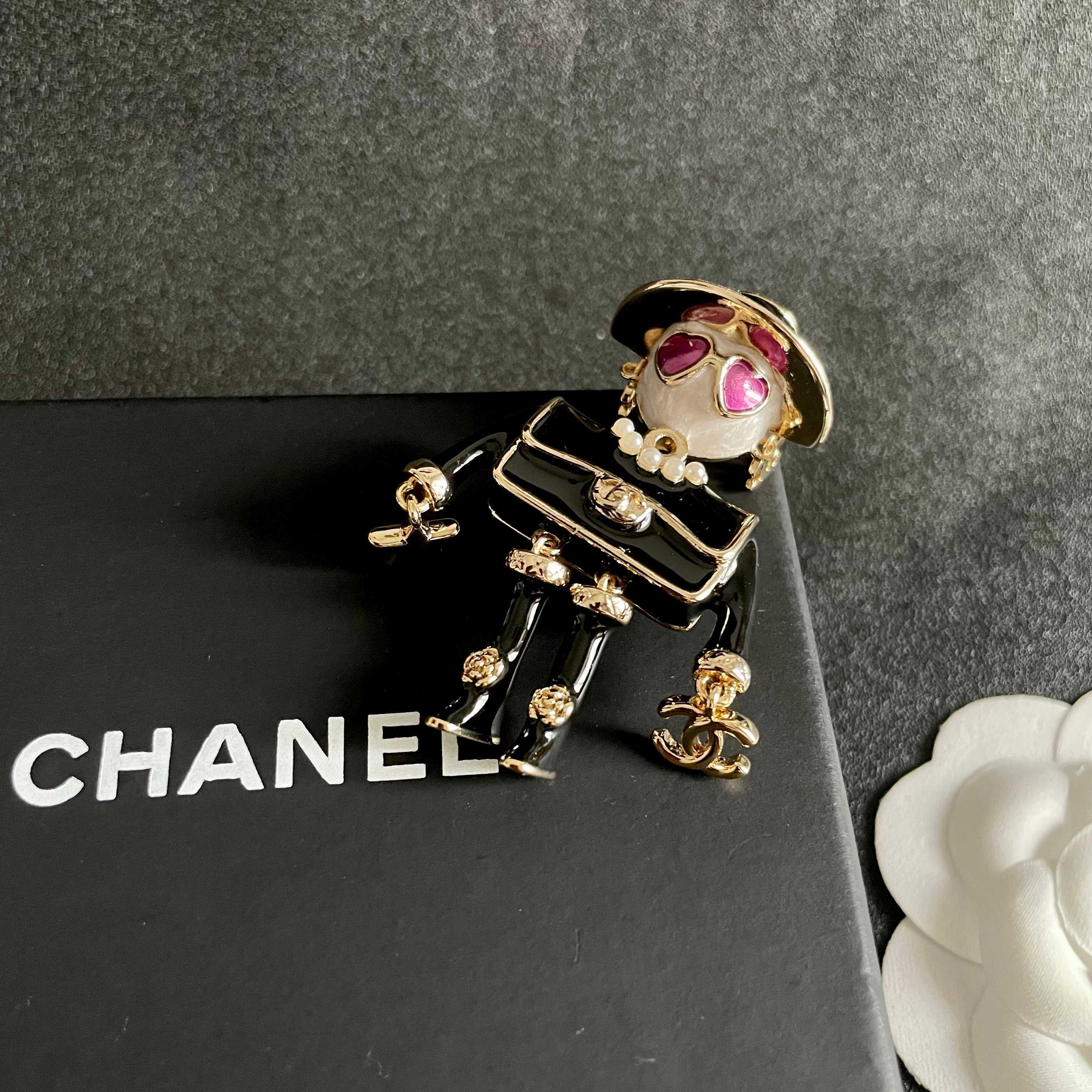 Chanel CC Logo Doll Robot Brooch brooch gold tone metal black enamel white faux pearl purple heart enamel white resin 4 5cm height