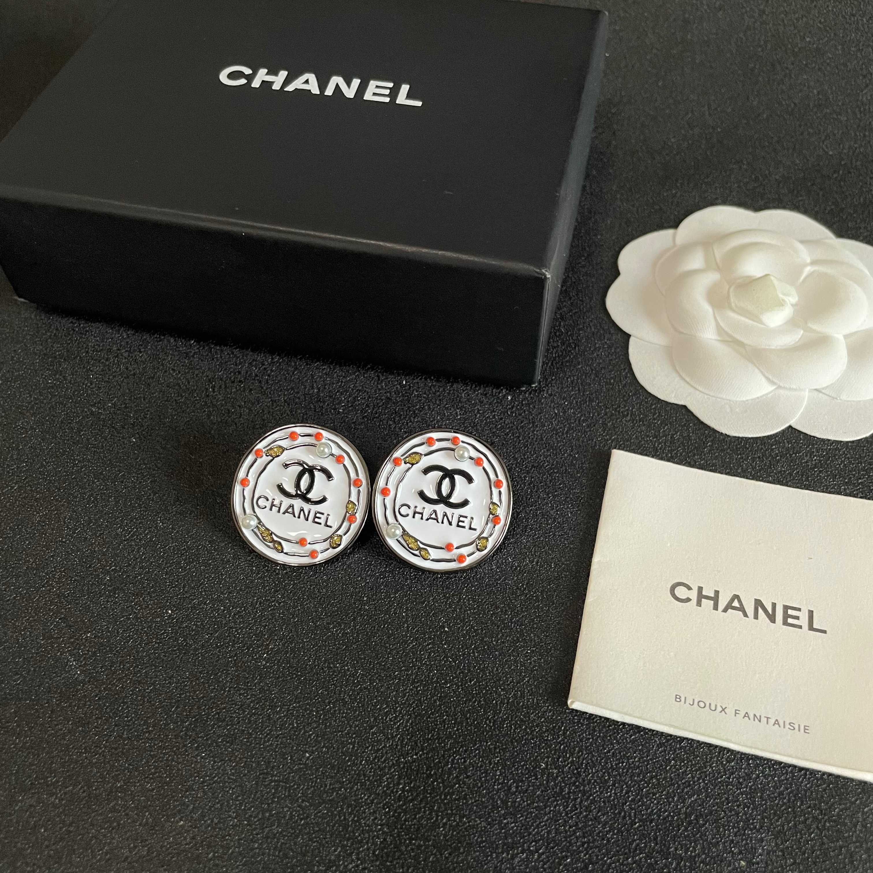 Chanel CC Logo Round Stud Earrings earrings Silver-tone metal with white enamel base black CC logo and text coral red and gold decorative accents faux pearl details 2cm diameter