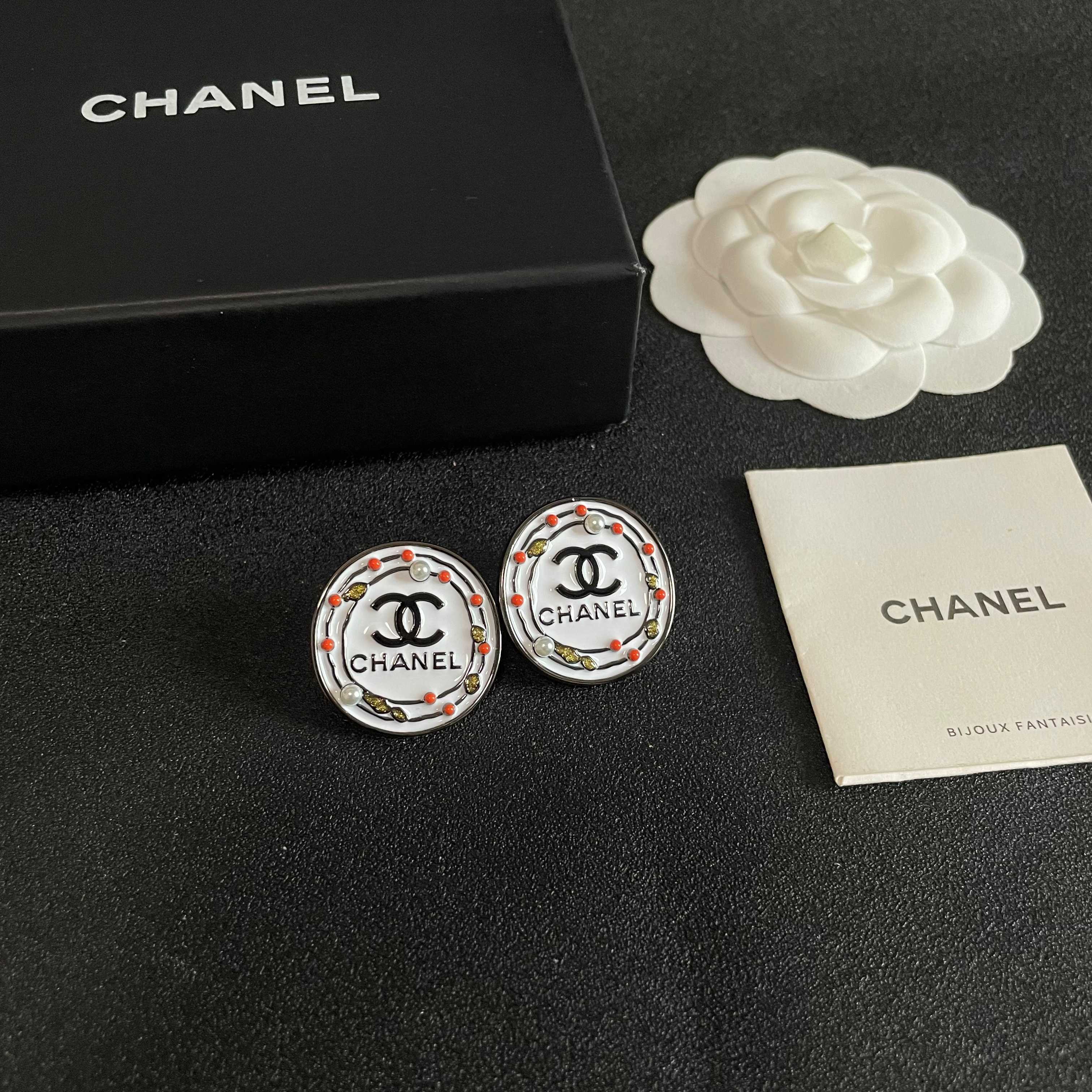 Chanel CC Logo Round Stud Earrings earrings Silver-tone metal with white enamel base black CC logo and text coral red and gold decorative accents faux pearl details 2cm diameter
