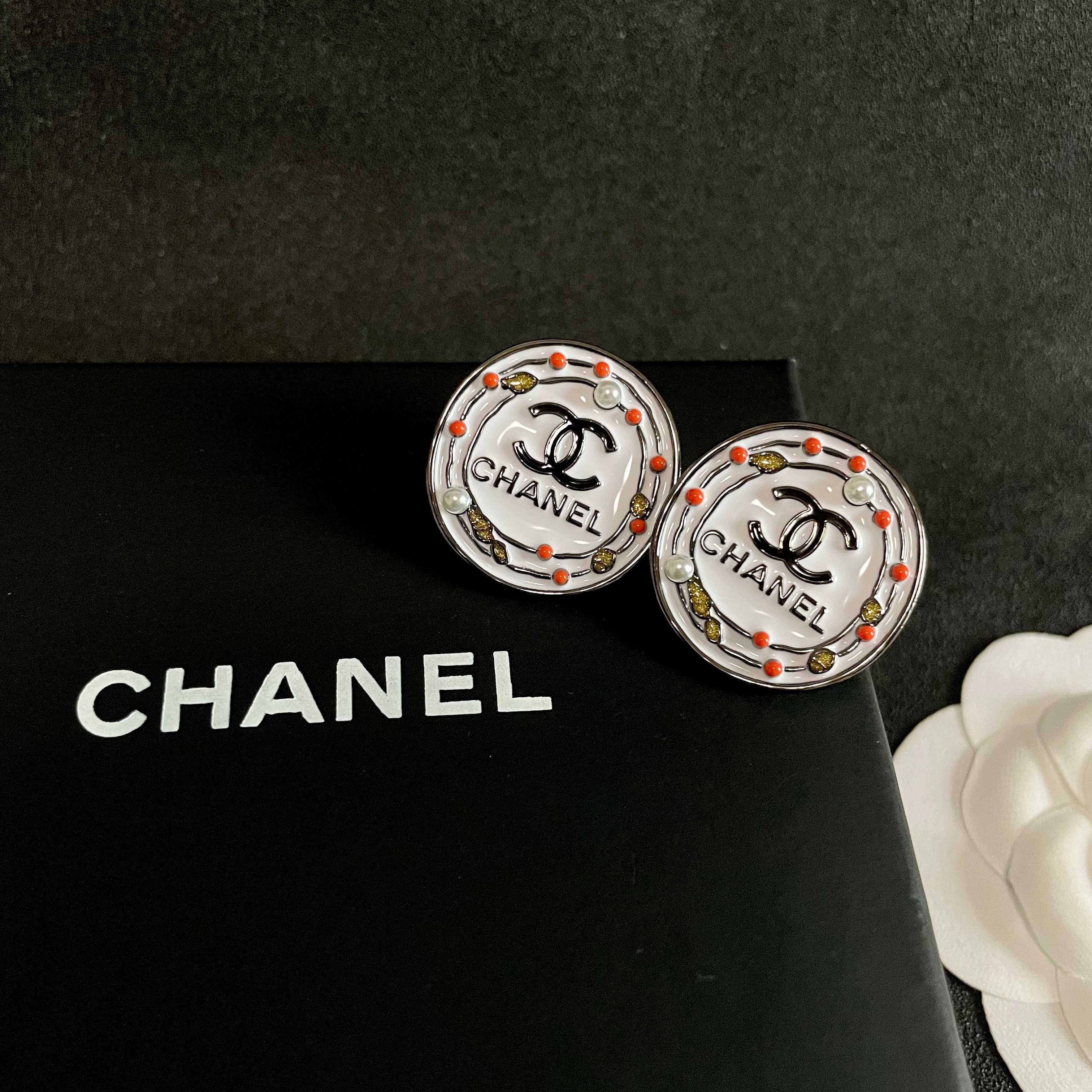 Chanel CC Logo Round Stud Earrings earrings Silver-tone metal with white enamel base black CC logo and text coral red and gold decorative accents faux pearl details 2cm diameter