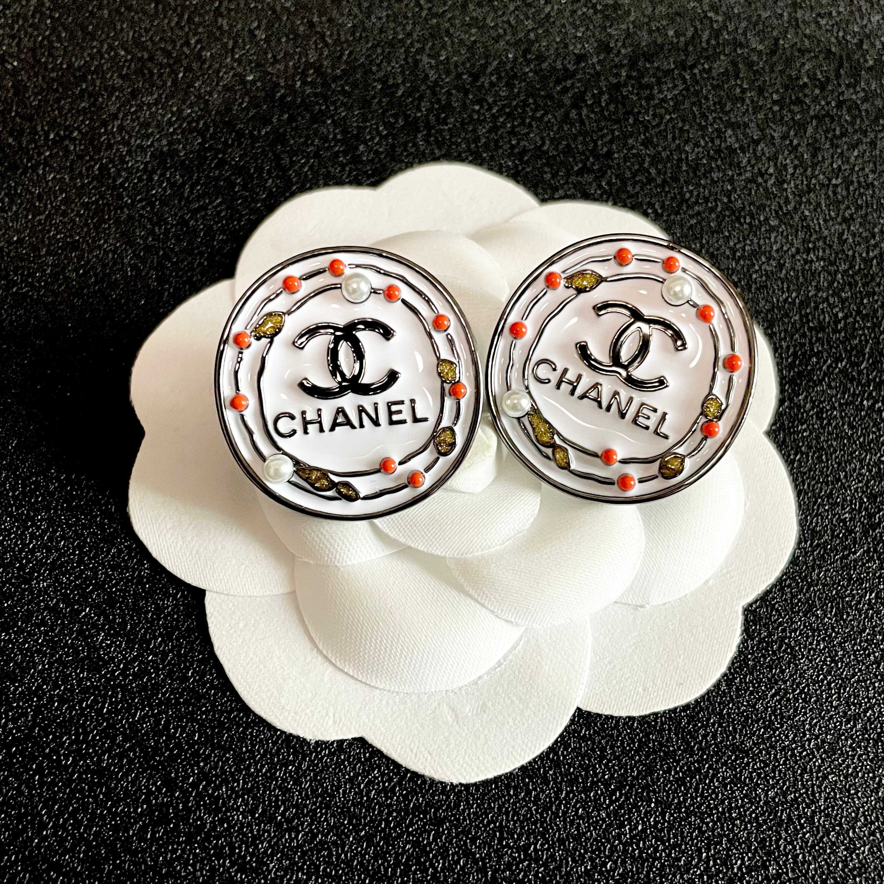 Chanel CC Logo Round Stud Earrings earrings Silver-tone metal with white enamel base black CC logo and text coral red and gold decorative accents faux pearl details 2cm diameter