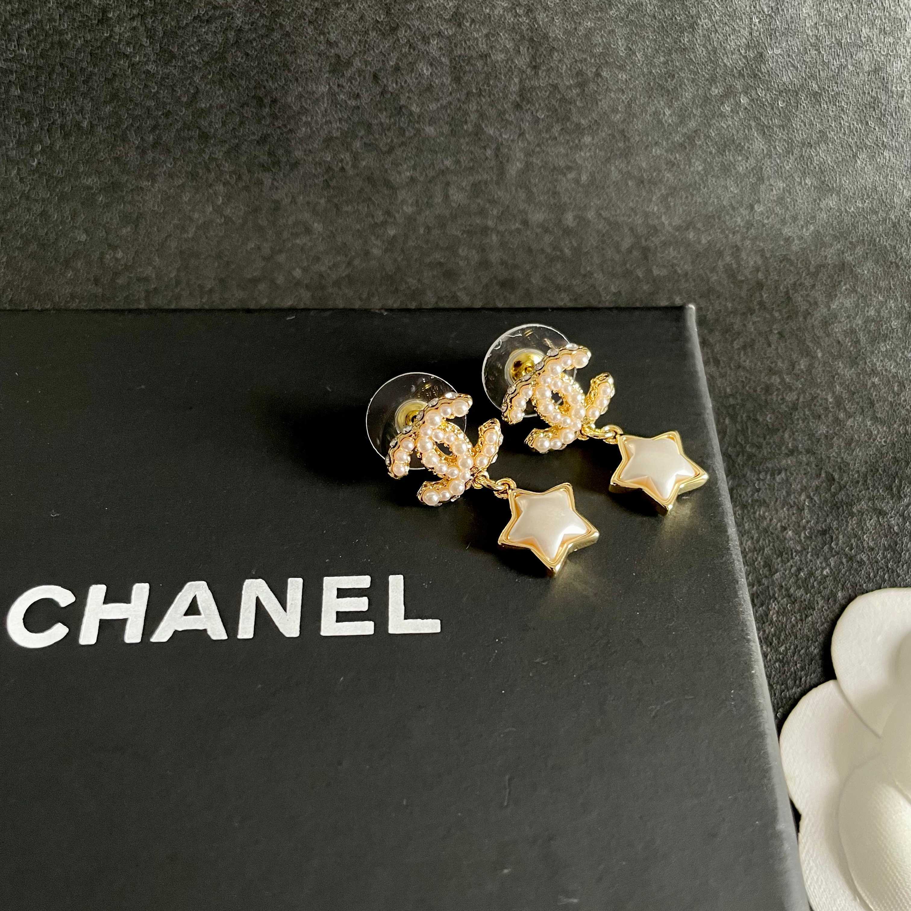 Chanel CC Star Drop Earrings earrings Gold-tone metal with cream pearl CC detailing and white mother-of-pearl star charms One Size drop length approx 2cm