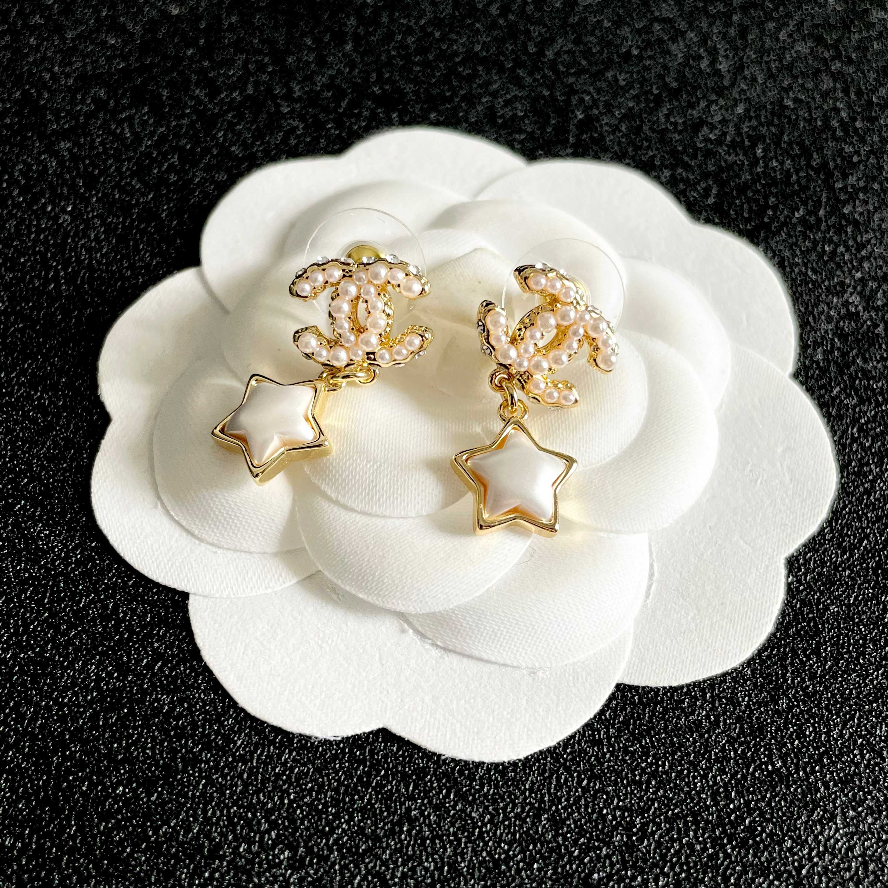 Chanel CC Star Drop Earrings earrings Gold-tone metal with cream pearl CC detailing and white mother-of-pearl star charms One Size drop length approx 2cm