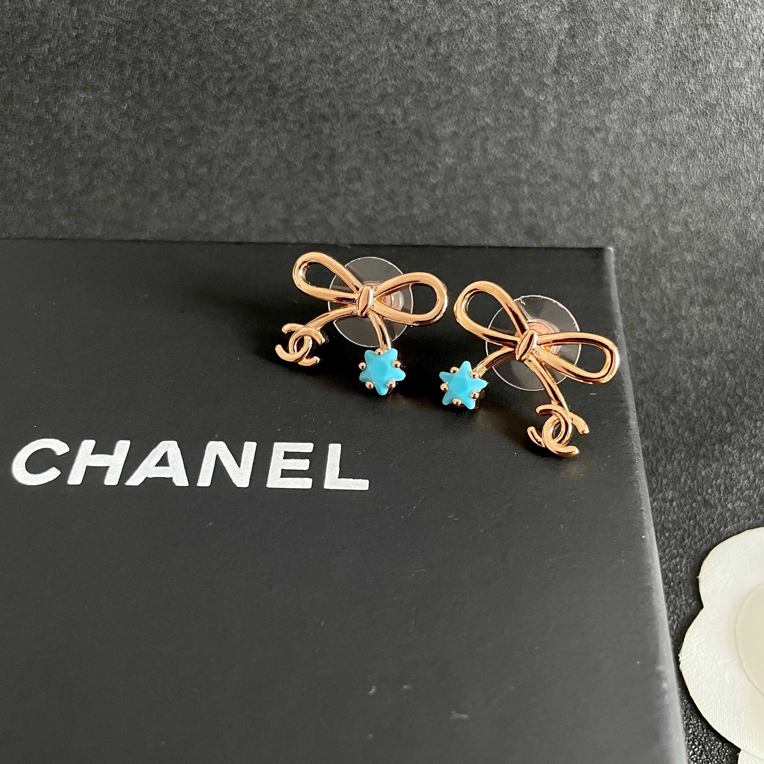 Chanel CC Bow Star Charm Stud Earrings earrings Rose gold light gold tone metal with clear crystal or turquoise blue star accents One Size standard stud earring dimensions approx 1 5cm width