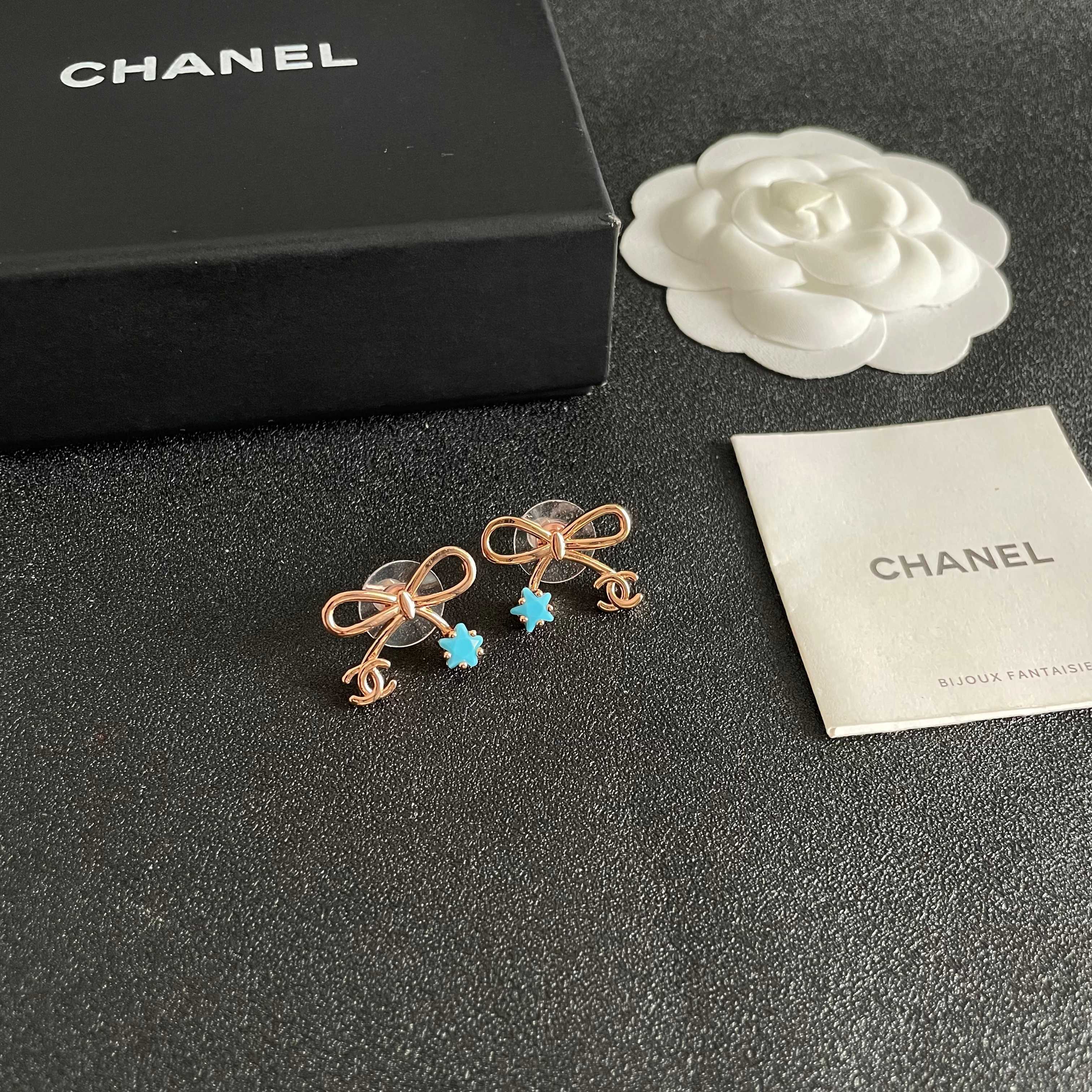 Chanel CC Bow Star Charm Stud Earrings earrings Rose gold light gold tone metal with clear crystal or turquoise blue star accents One Size standard stud earring dimensions approx 1 5cm width