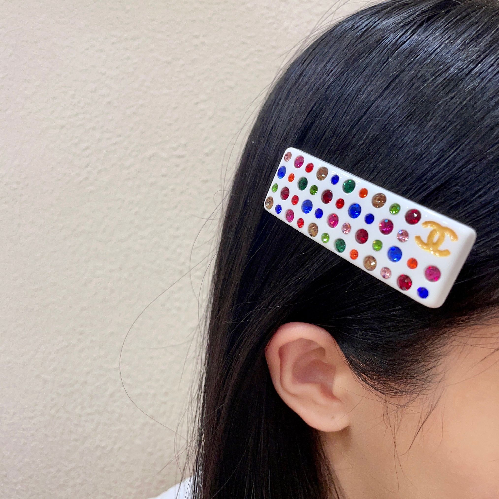 Chanel CC Logo Multicolor Crystal Resin Hair Barrette brooch White resin base with gold-tone interlocking CC logo multicolor faceted crystals in red blue green pink orange champagne and light pink hues 8cm length