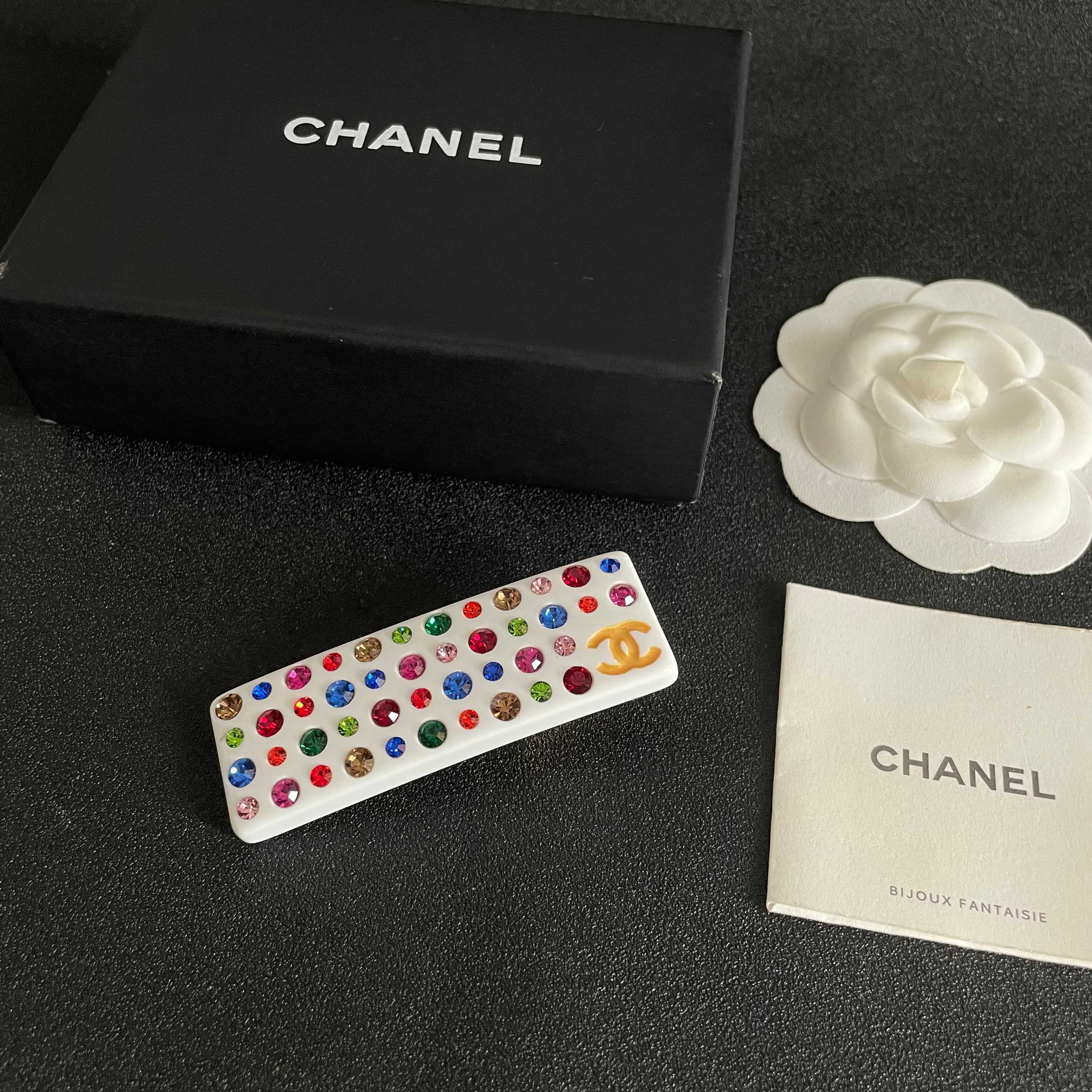 Chanel CC Logo Multicolor Crystal Resin Hair Barrette brooch White resin base with gold-tone interlocking CC logo multicolor faceted crystals in red blue green pink orange champagne and light pink hues 8cm length