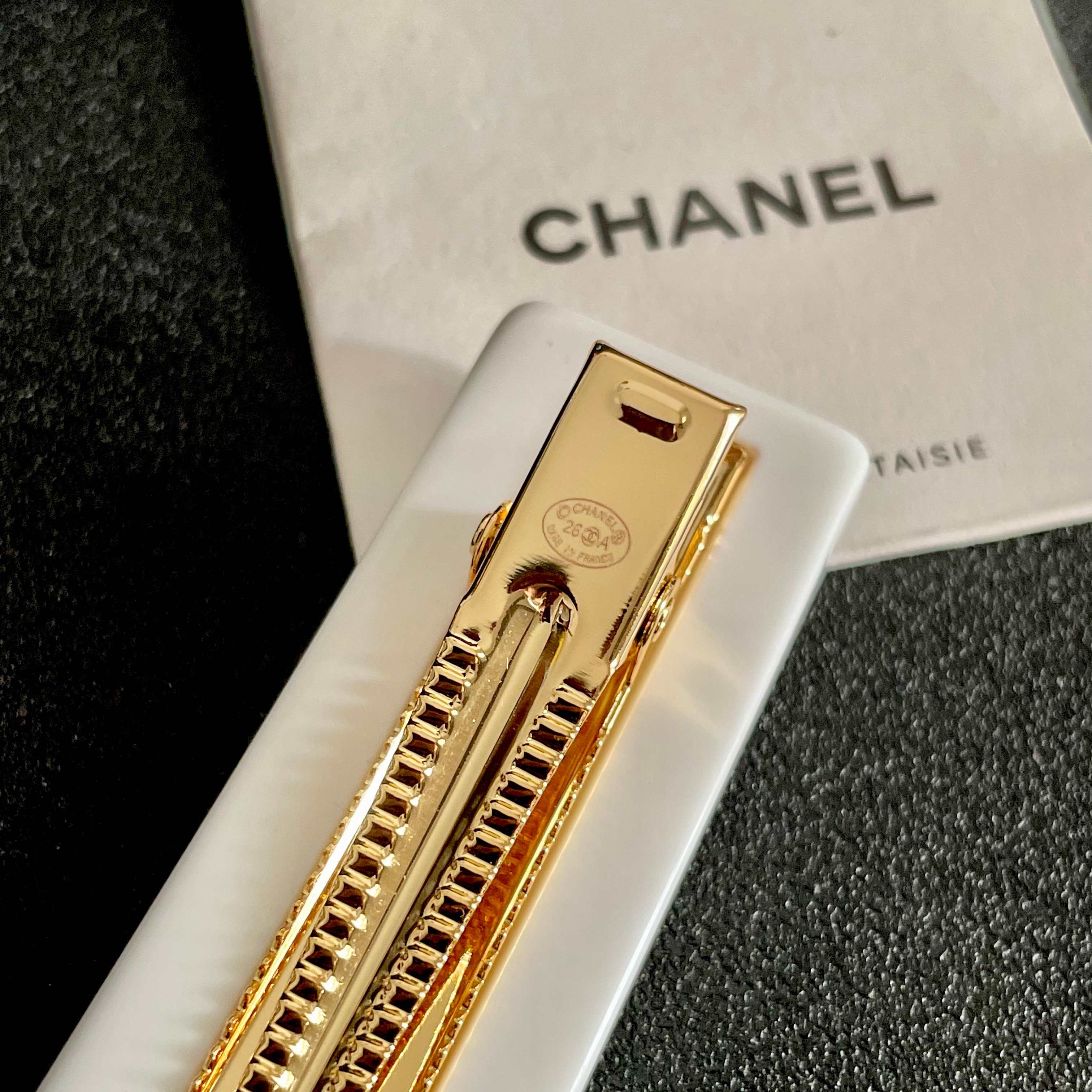 Chanel CC Logo Multicolor Crystal Resin Hair Barrette brooch White resin base with gold-tone interlocking CC logo multicolor faceted crystals in red blue green pink orange champagne and light pink hues 8cm length