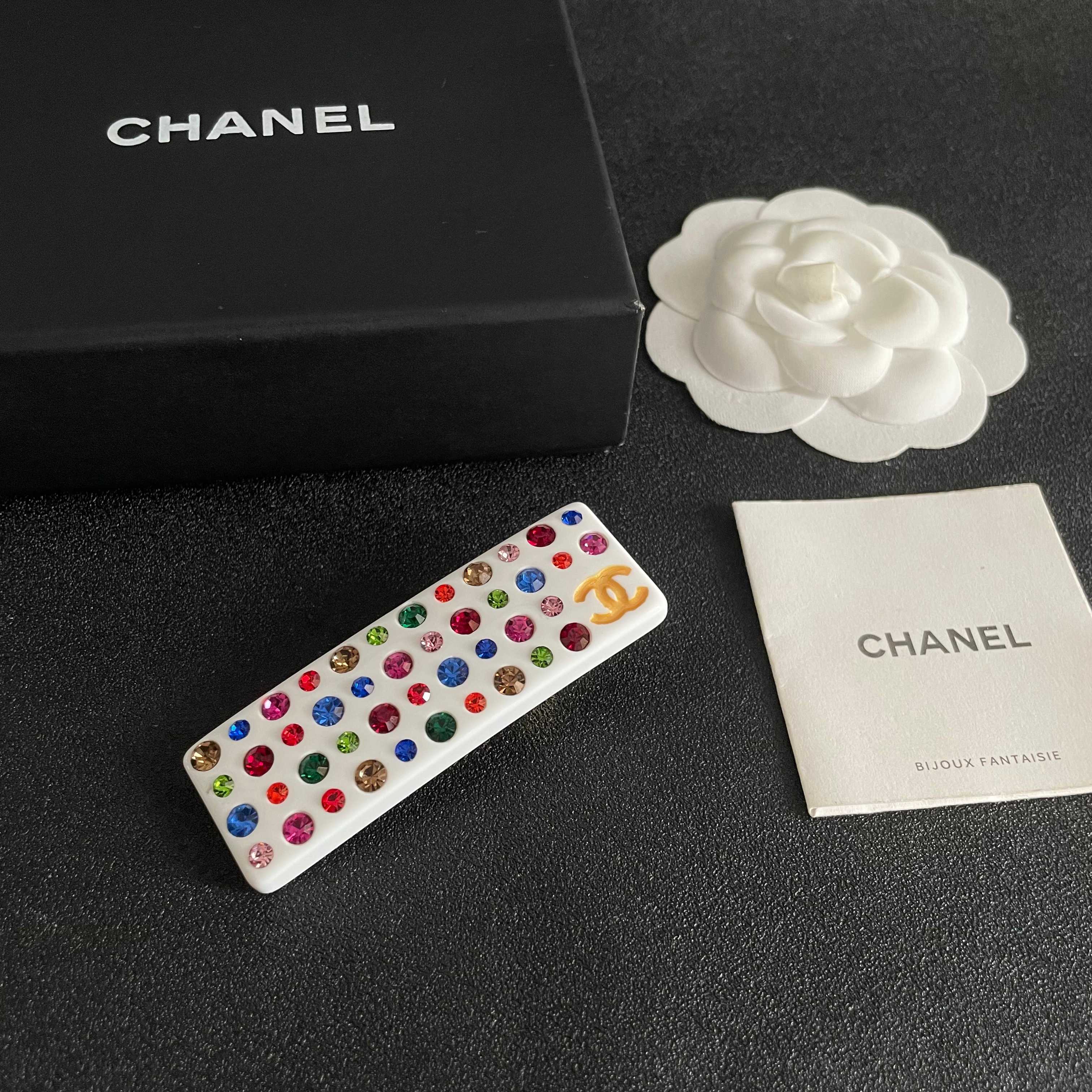 Chanel CC Logo Multicolor Crystal Resin Hair Barrette brooch White resin base with gold-tone interlocking CC logo multicolor faceted crystals in red blue green pink orange champagne and light pink hues 8cm length