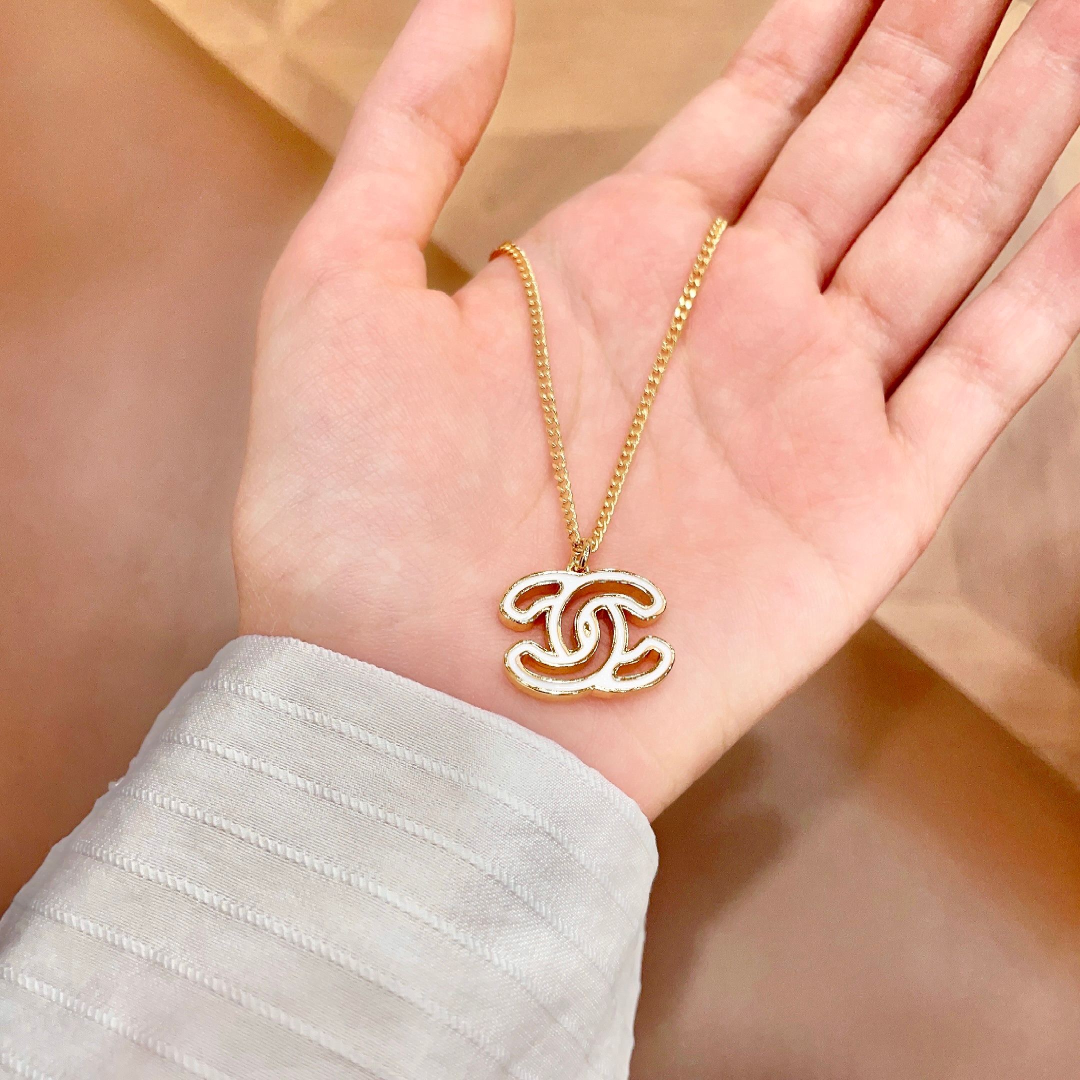 Chanel CC Logo Pendant Necklace necklace Gold-tone metal with white enamel fill 42cm