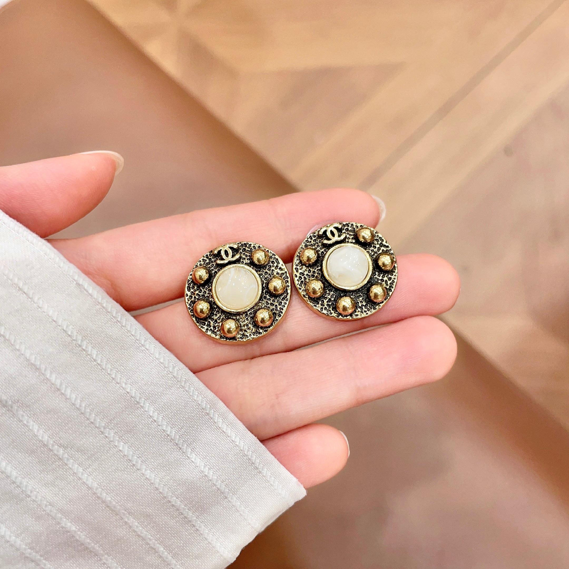 Chanel CC Logo Round Stud Earrings earrings antique gold metal white mother-of-pearl center stone 1 5cm diameter