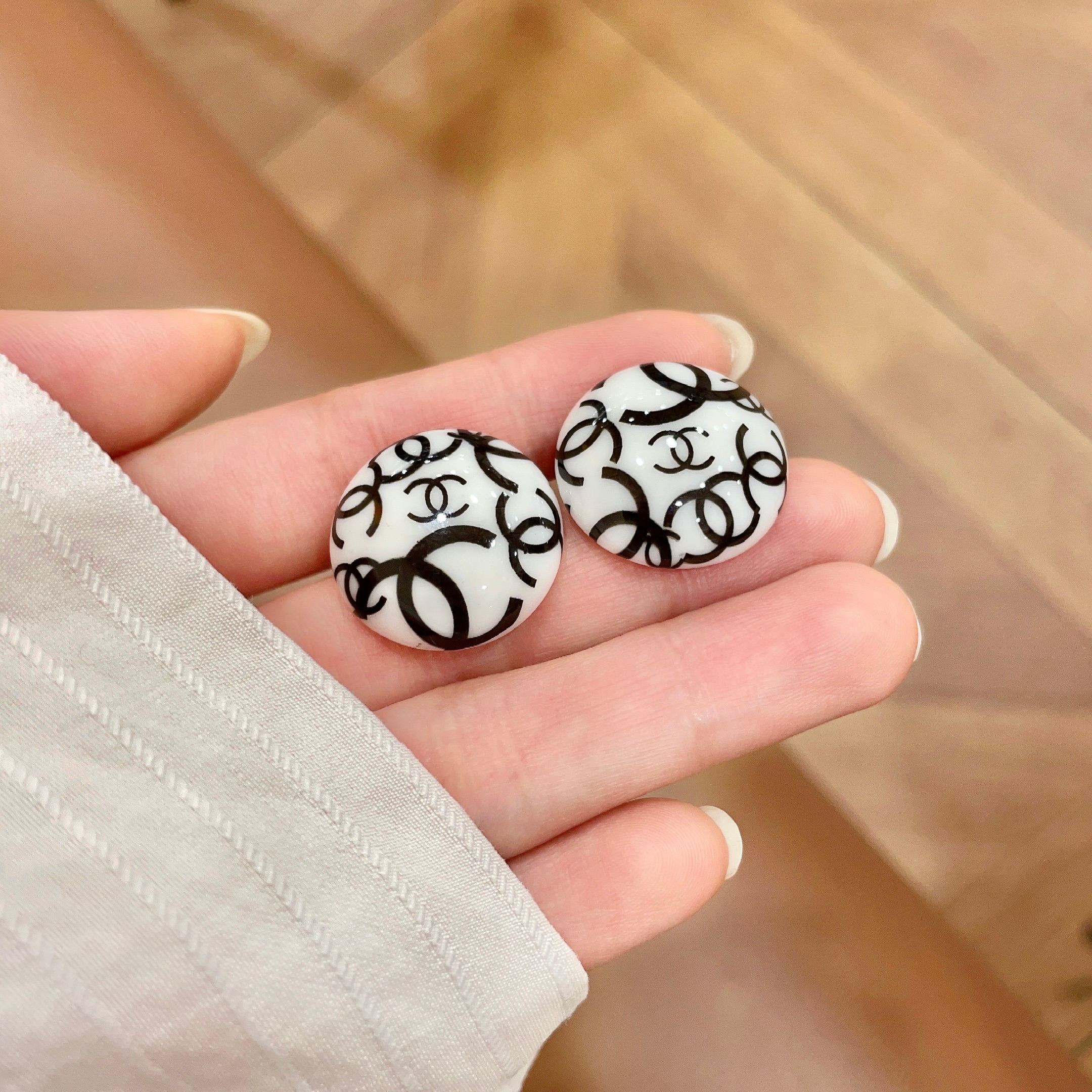 Chanel CC Logo Round Stud Earrings earrings white resin base with black interlocking CC logo detailing 2cm diameter